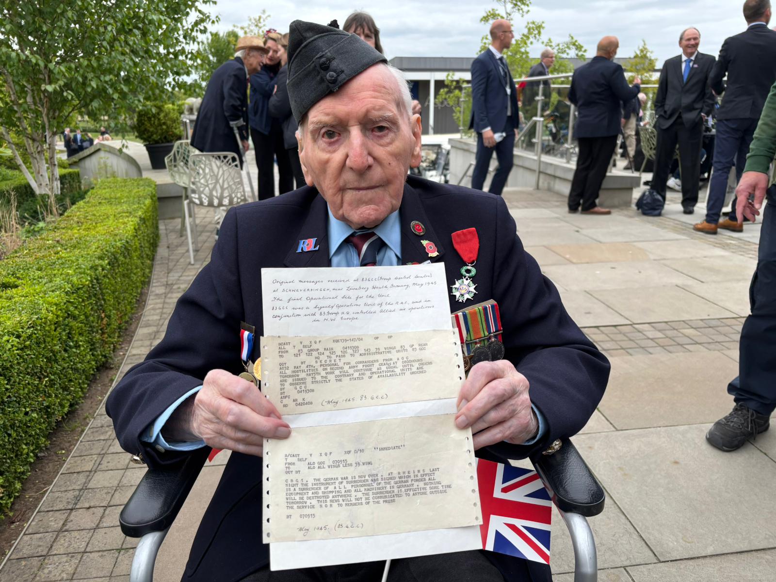 Bernard Morgan, 101, with the original telex he received two days before VE Day in 1945 explaining that the war was over