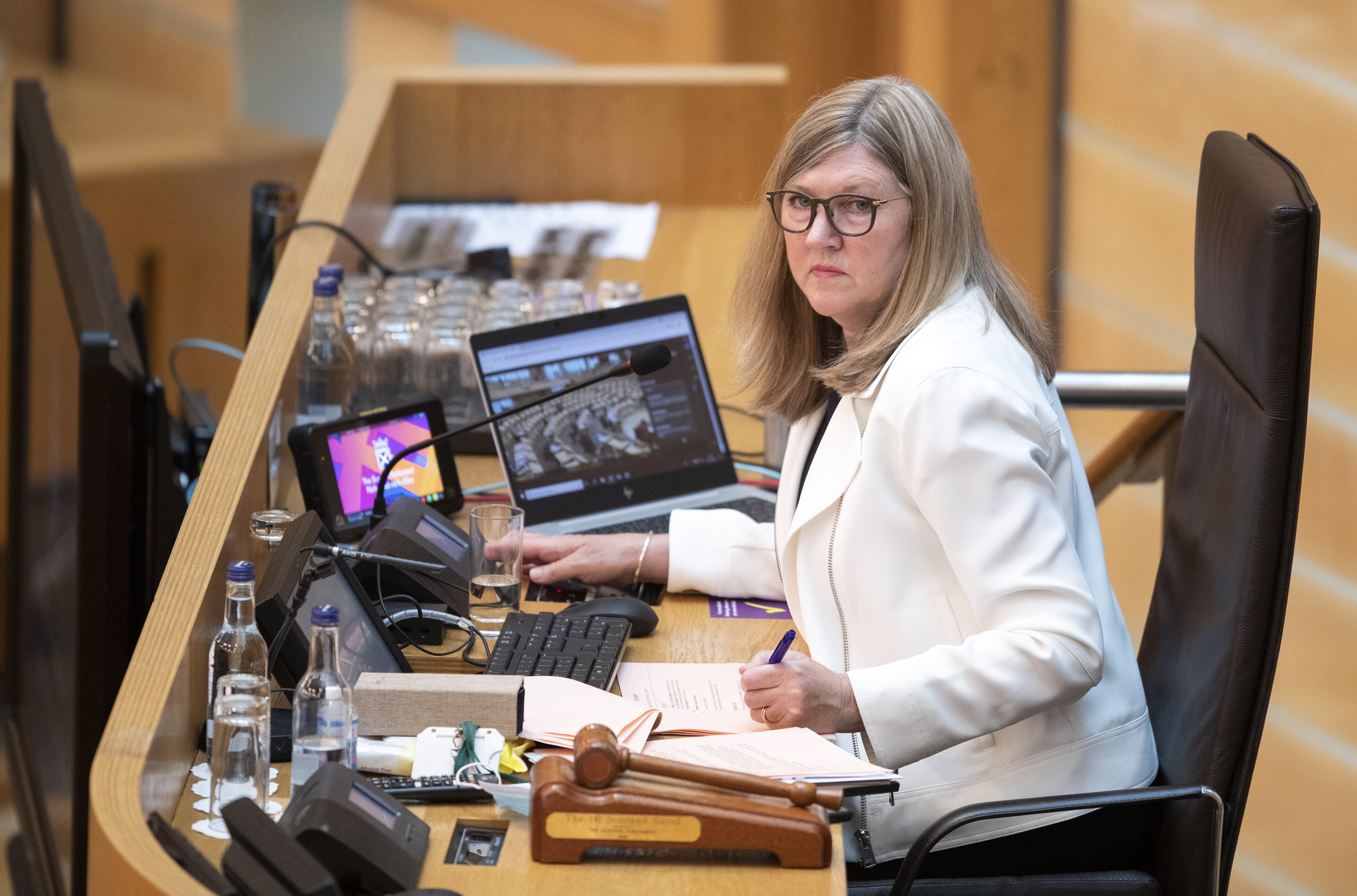 Side view of Alison Johnstone sitting at her desk in Holyrood
