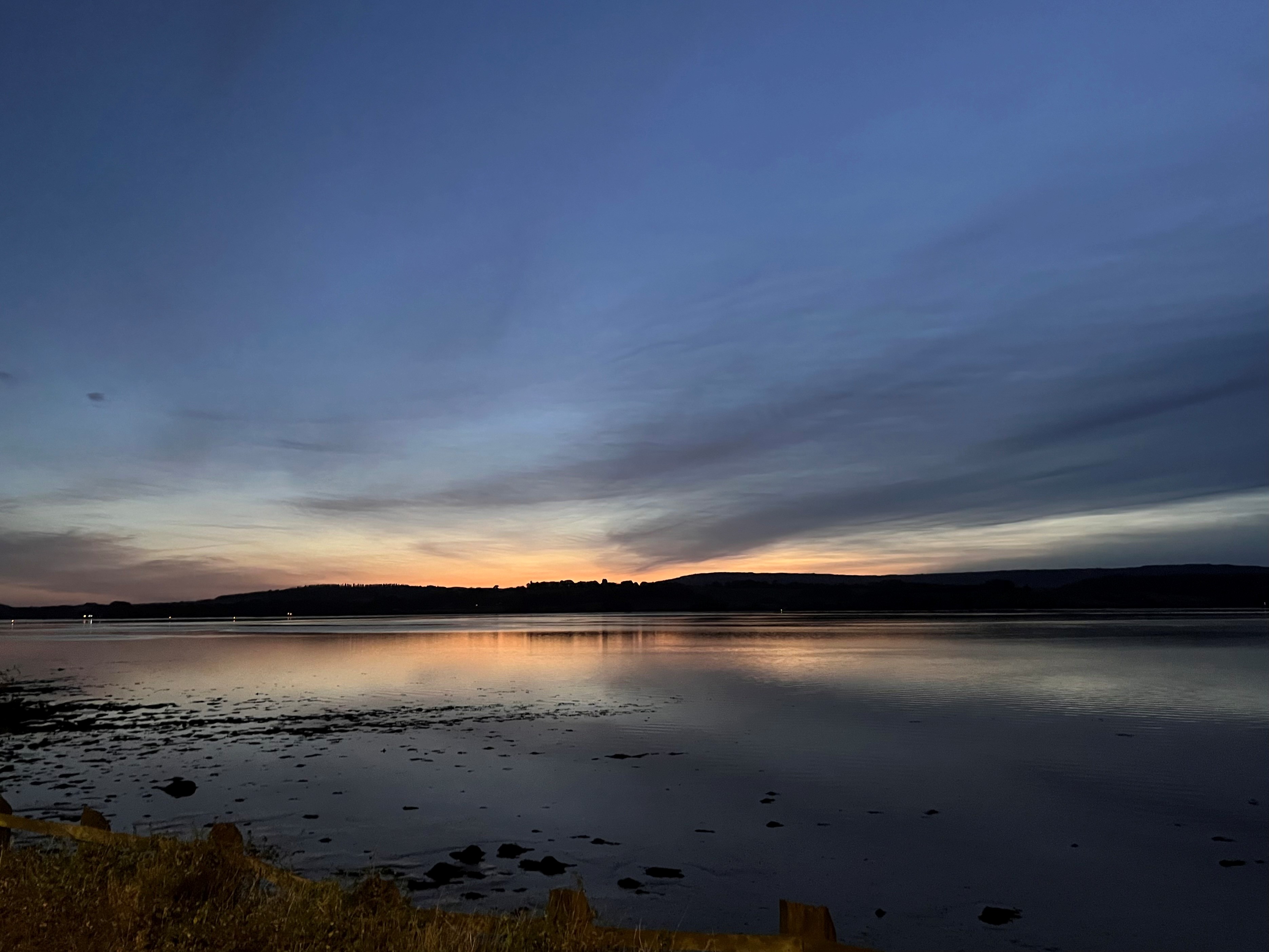 View across the Exe estuary at sunset with last light reflecting on the water and mud flats