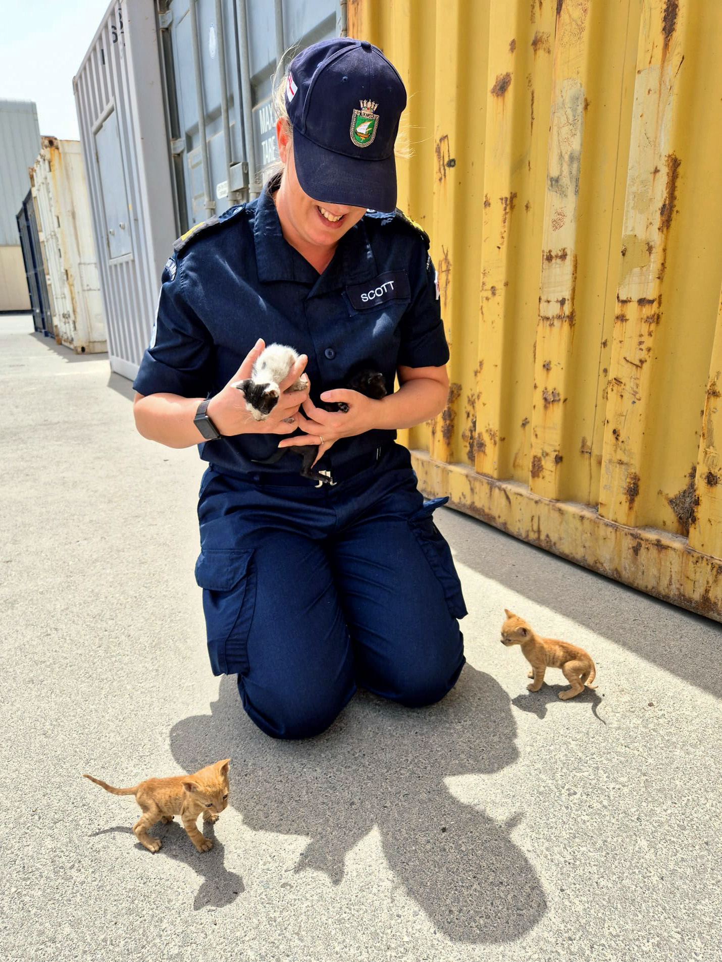 Petty Officer Kirsty Scott with three of the kittens