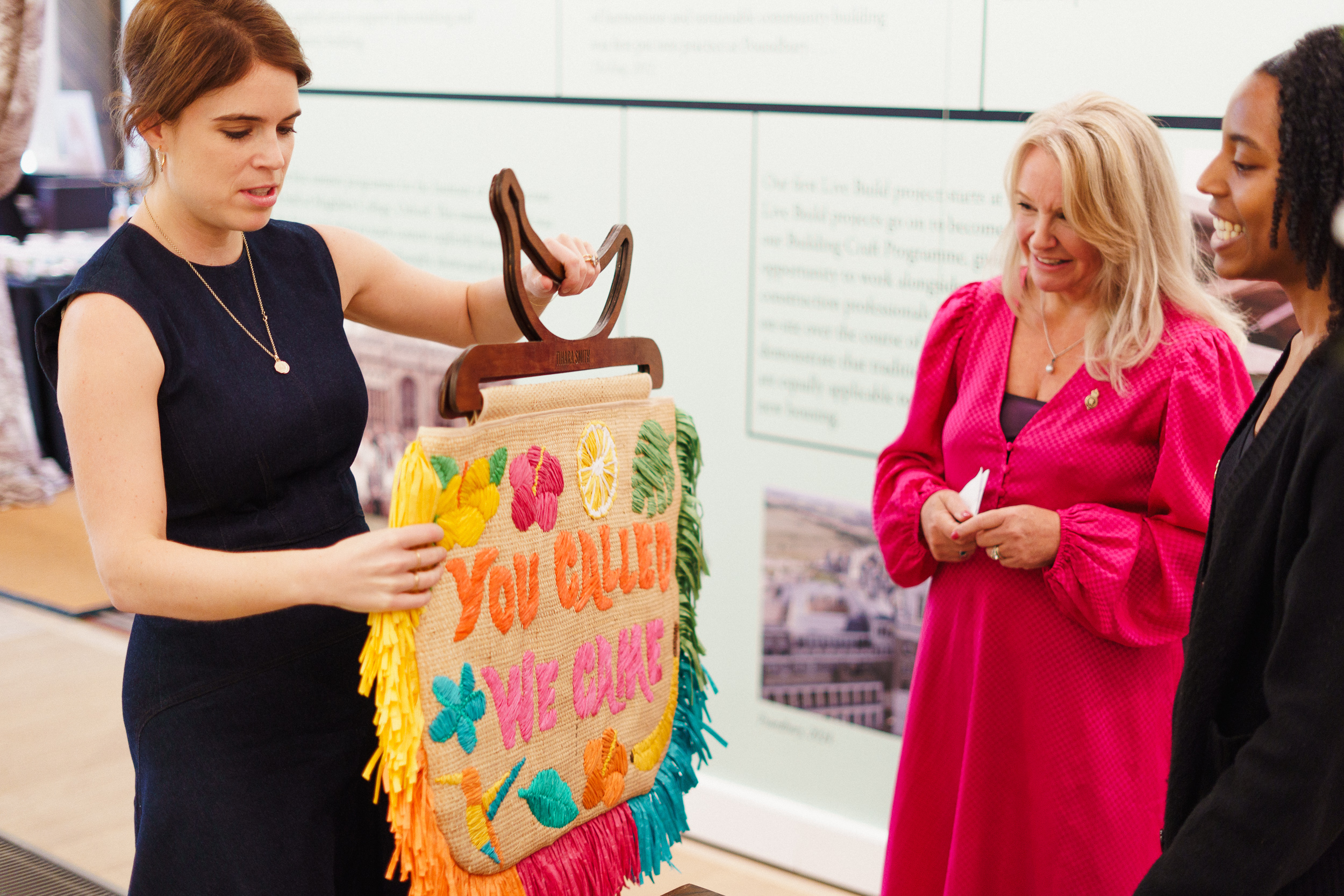 Eugenie holds an embroidered artwork at the Garrison Chapel while visiting The King's Foundation's new network