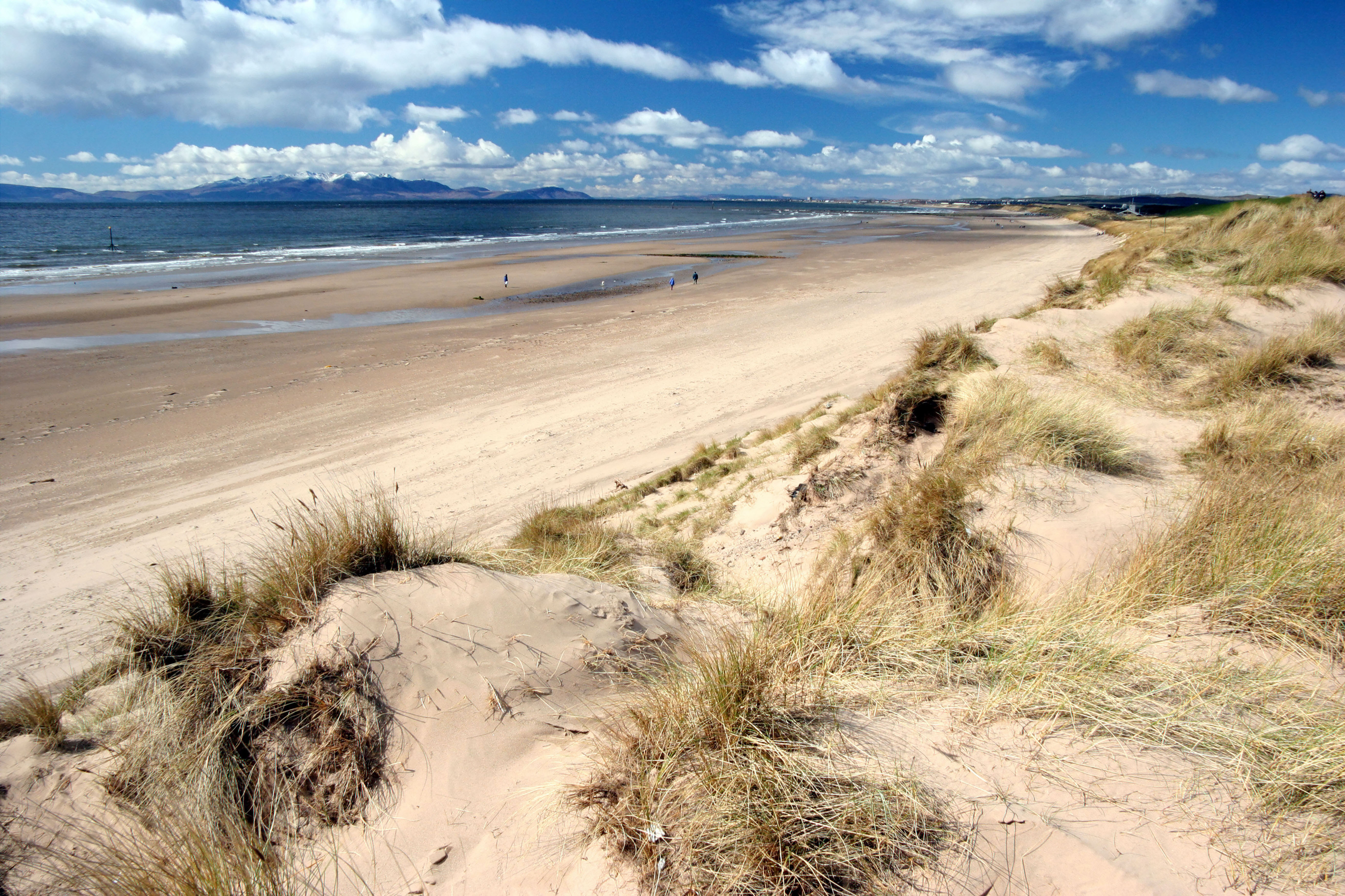 View of Irvine beach in the sunshine, with the Isle of Arran visible across the sea