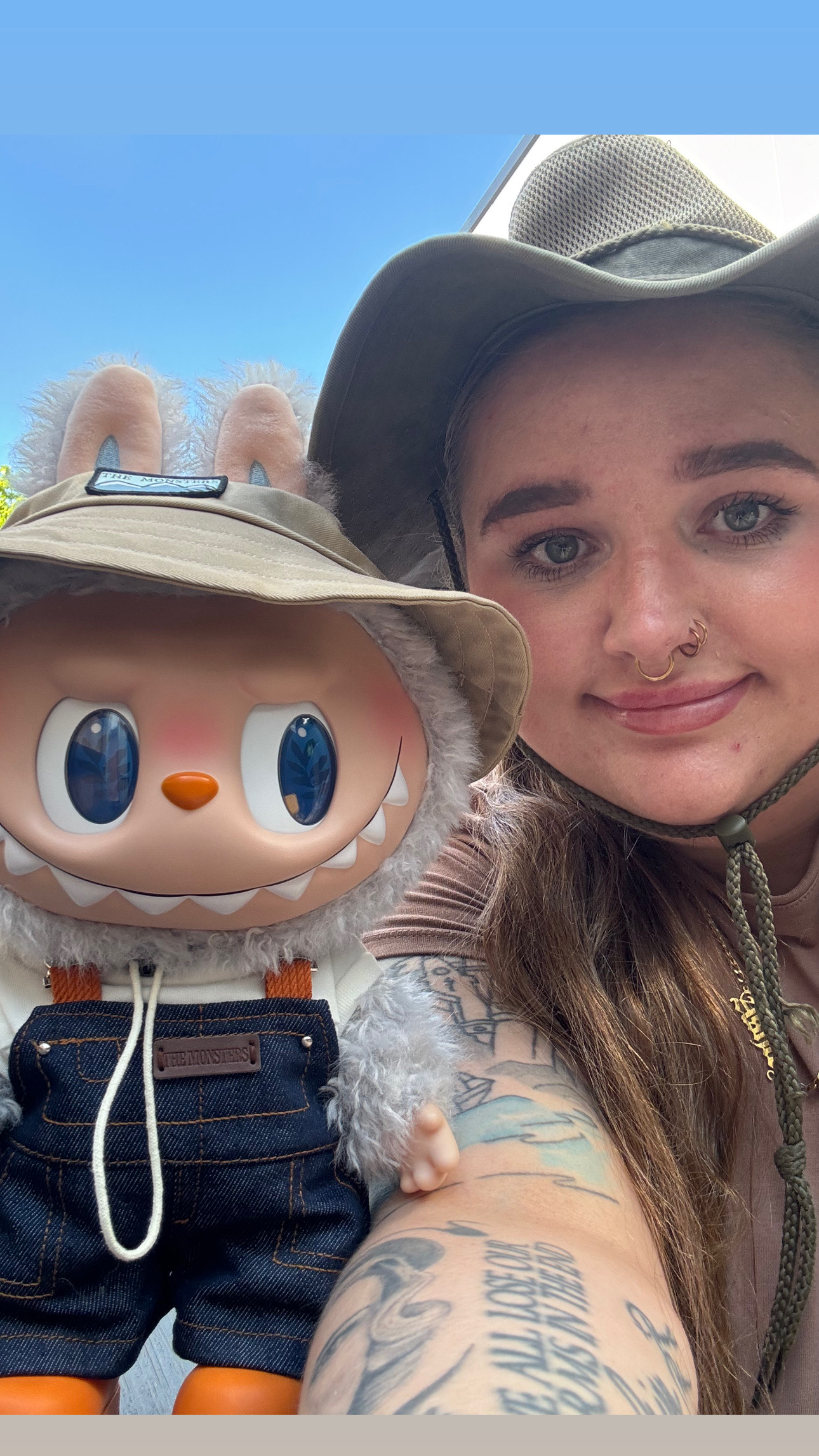 Woman taking a selfie with a viral Labubu doll