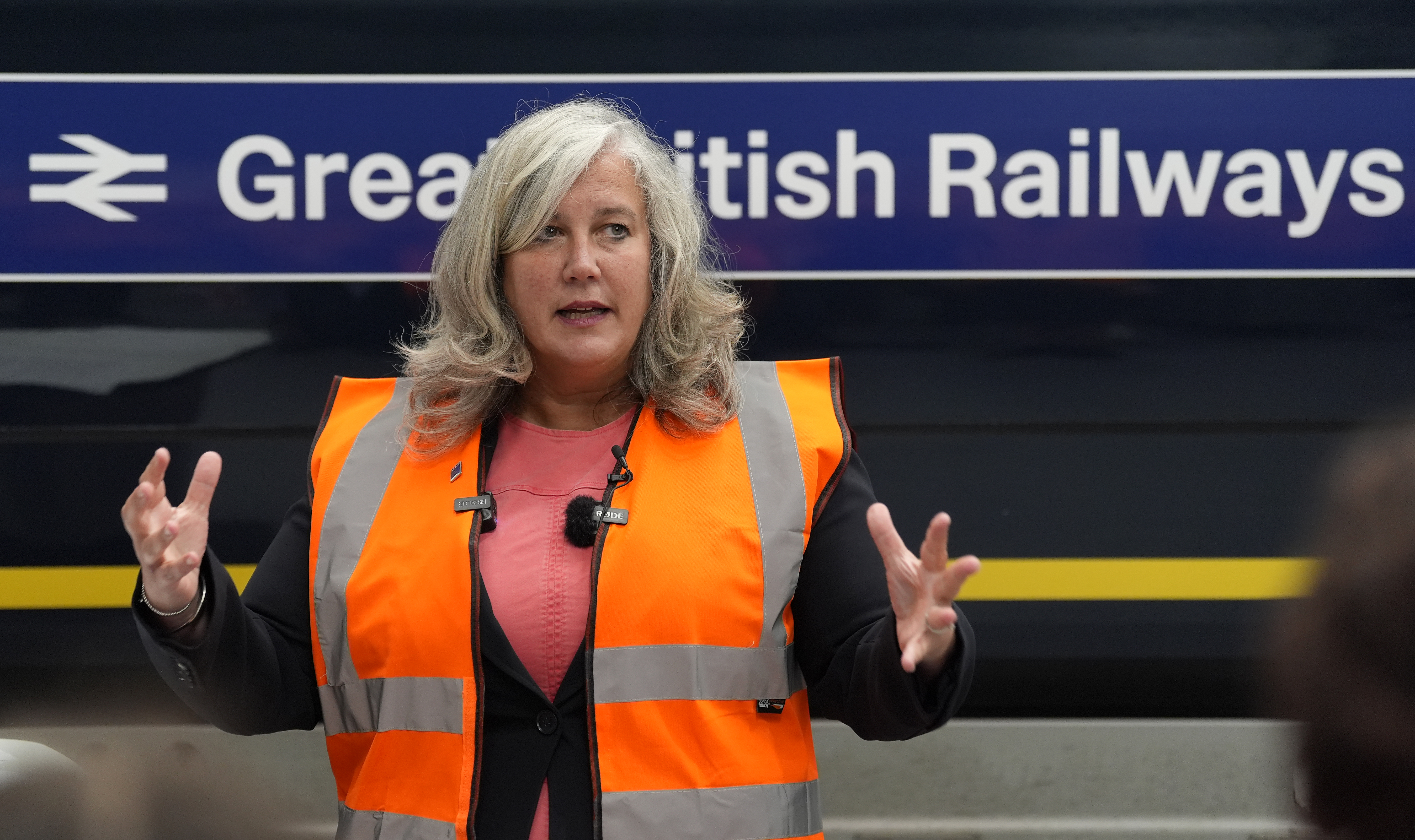 Transport Secretary Heidi Alexander giving a speech in front of a train