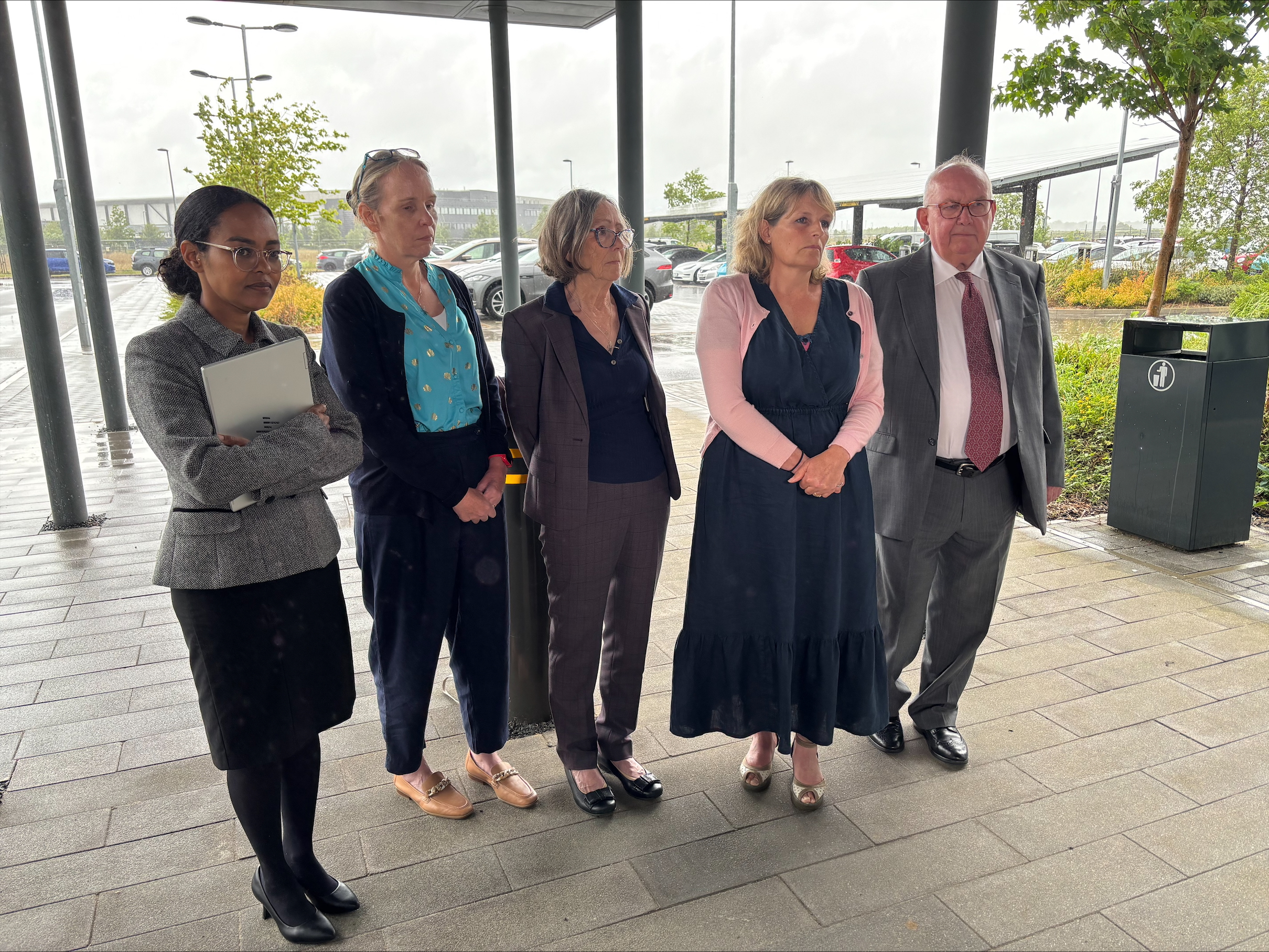 Stephen Chamberlain's widow Karen (second from right) and father Grenville Chamberlain spoke outside court after his inquest. (Sam Russell/ PA)