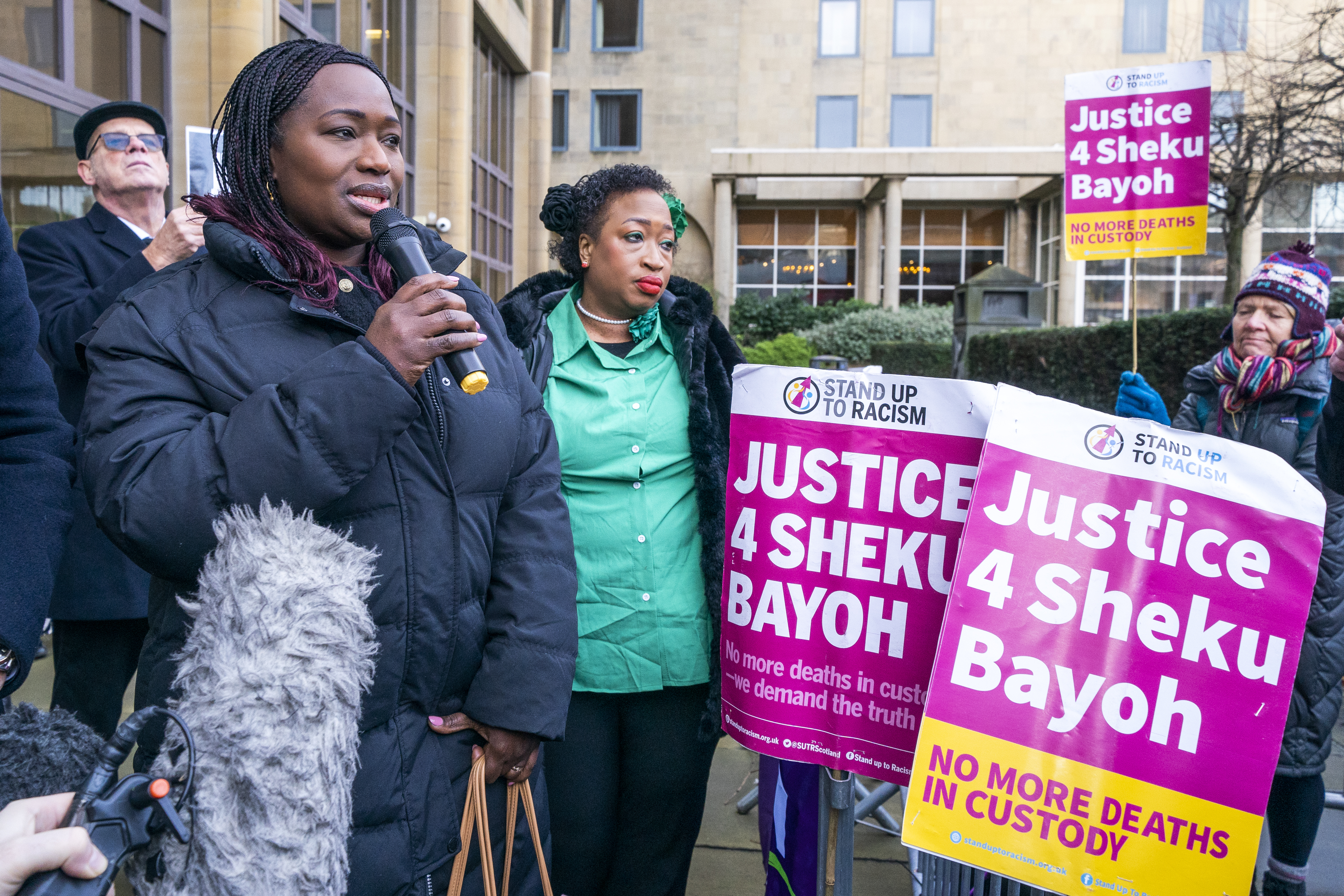 Sisters of Sheku Bayoh standing amongst campaigners