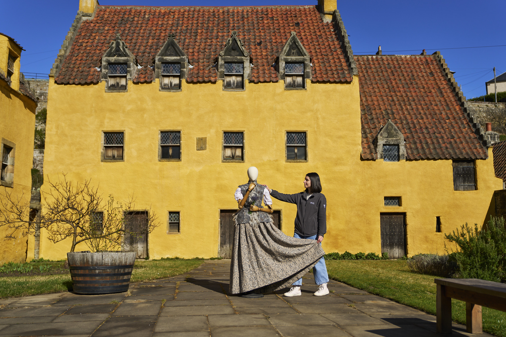 Dress being displayed by a woman outside Culross Palace