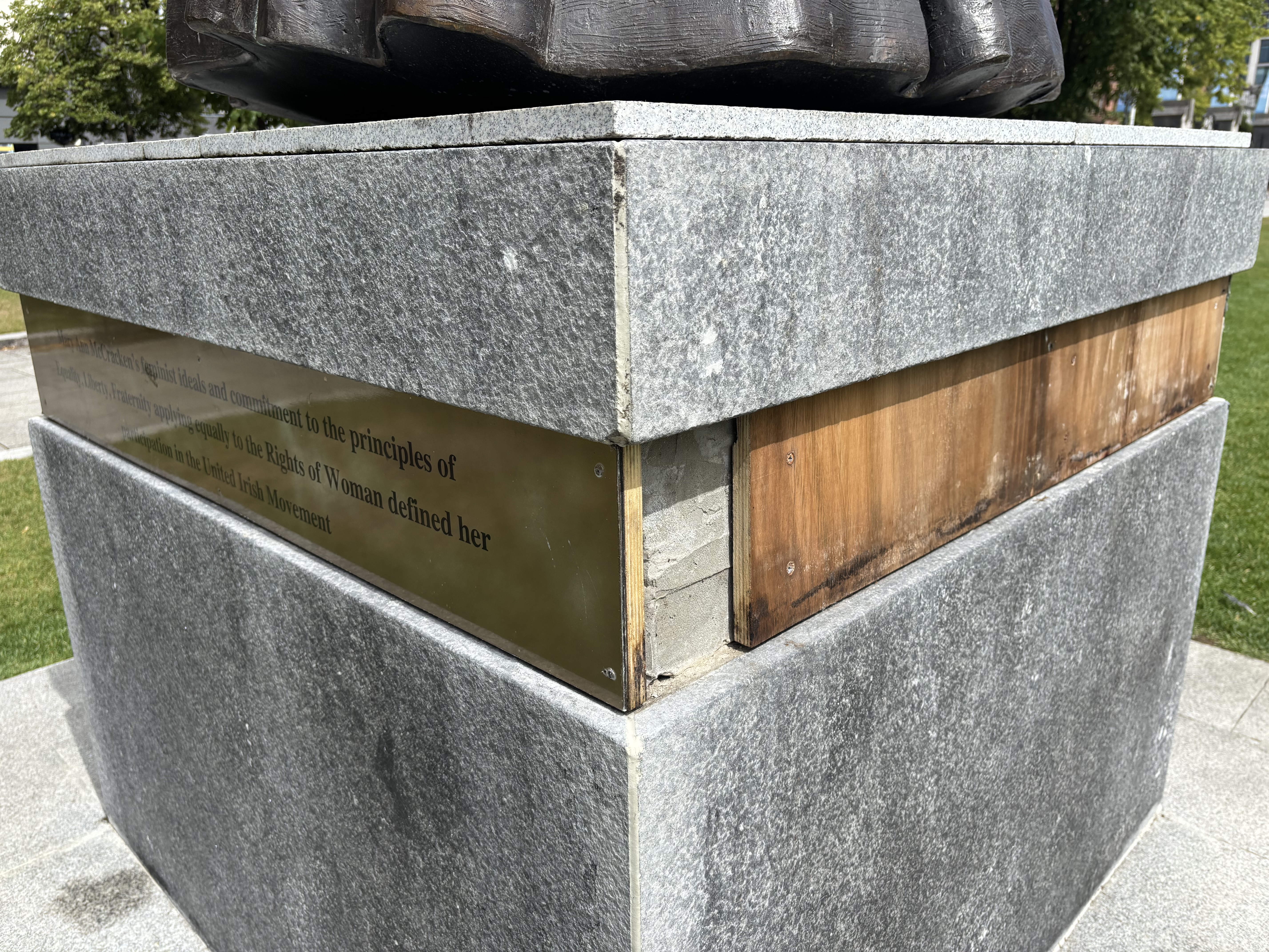 Damage to part of a base of a statue of Mary Ann McCracken