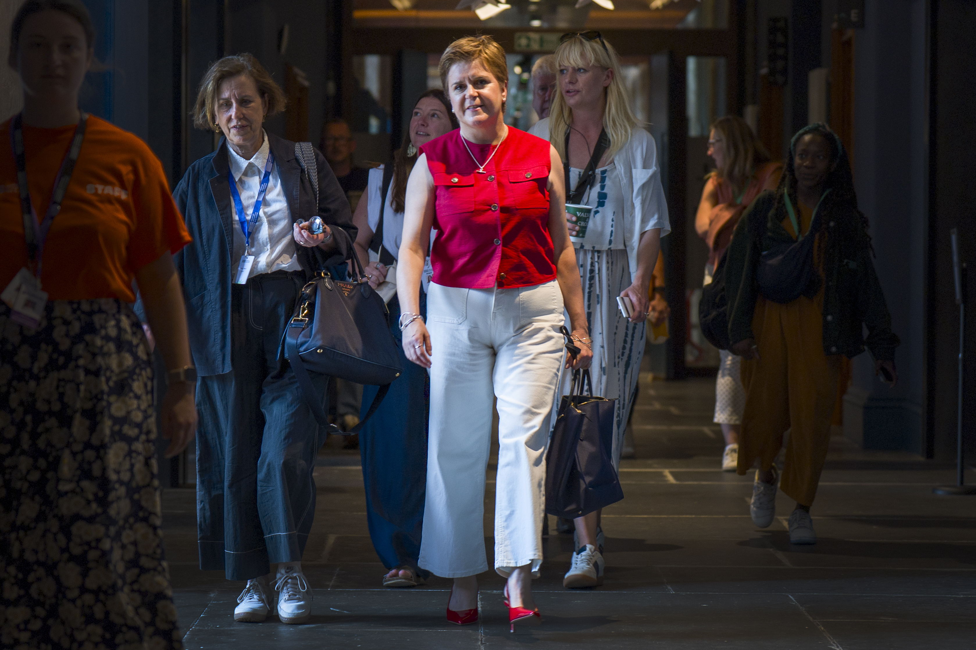 Nicola Sturgeon walking along corridor
