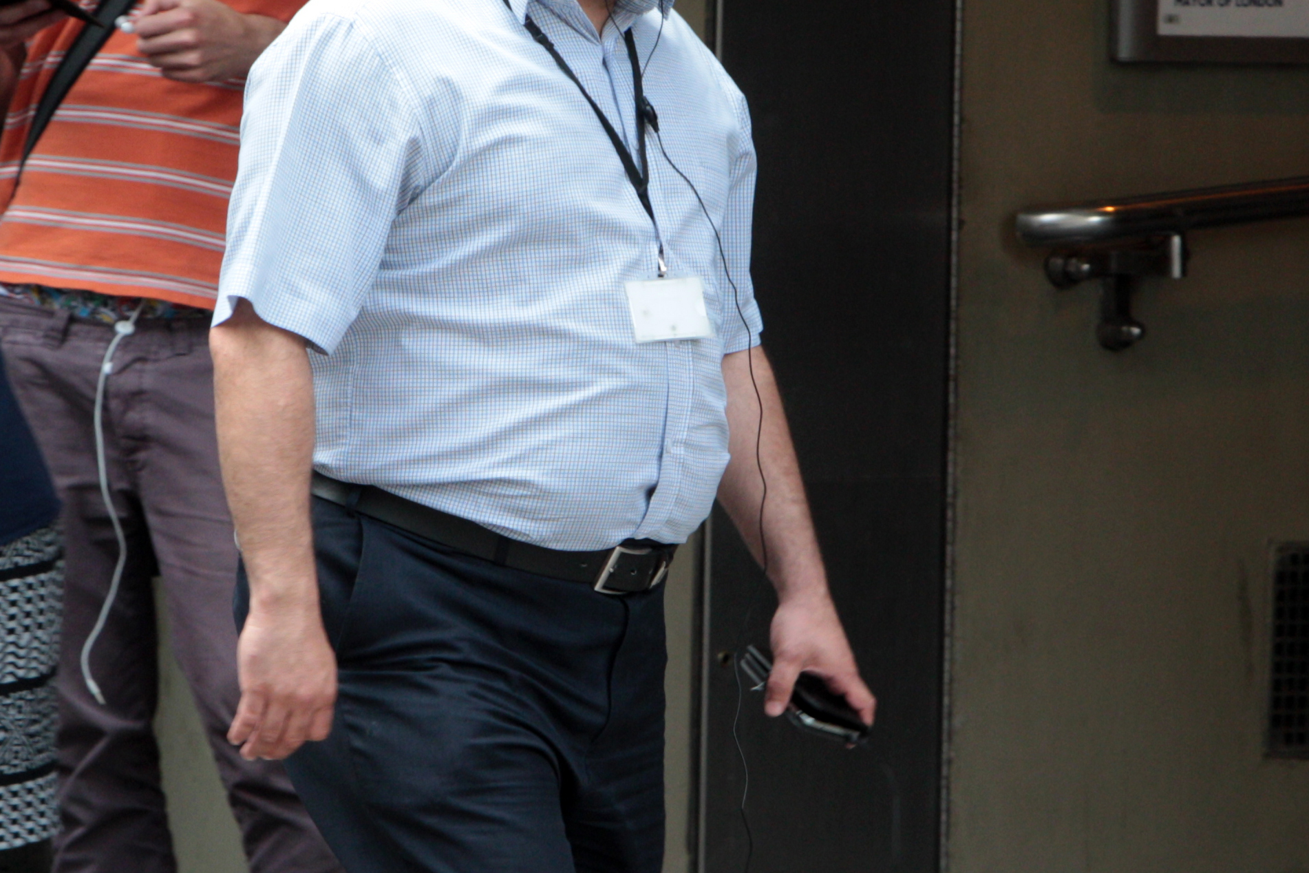 View of an overweight man walking outside