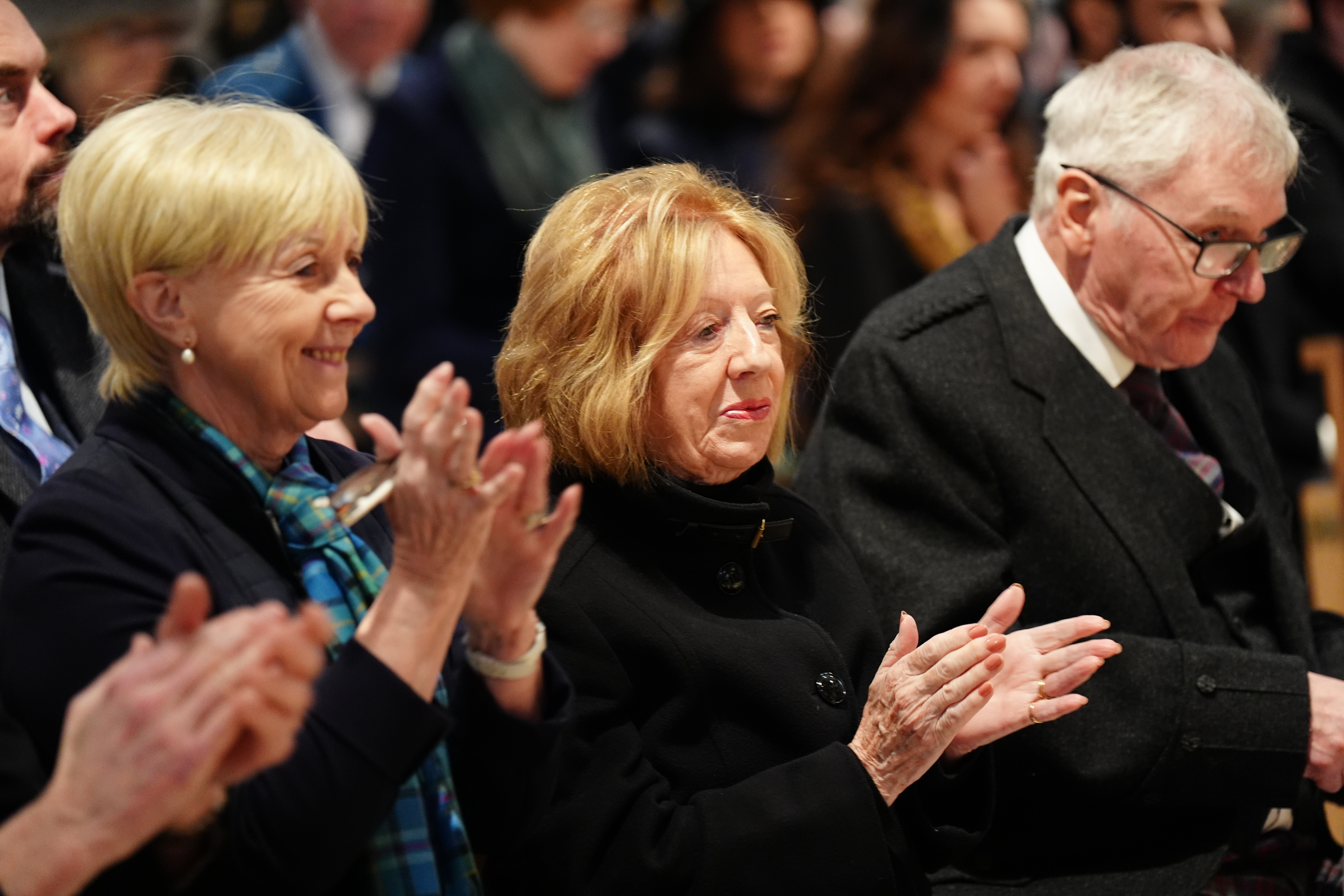 Moira Salmond applauds during a church service