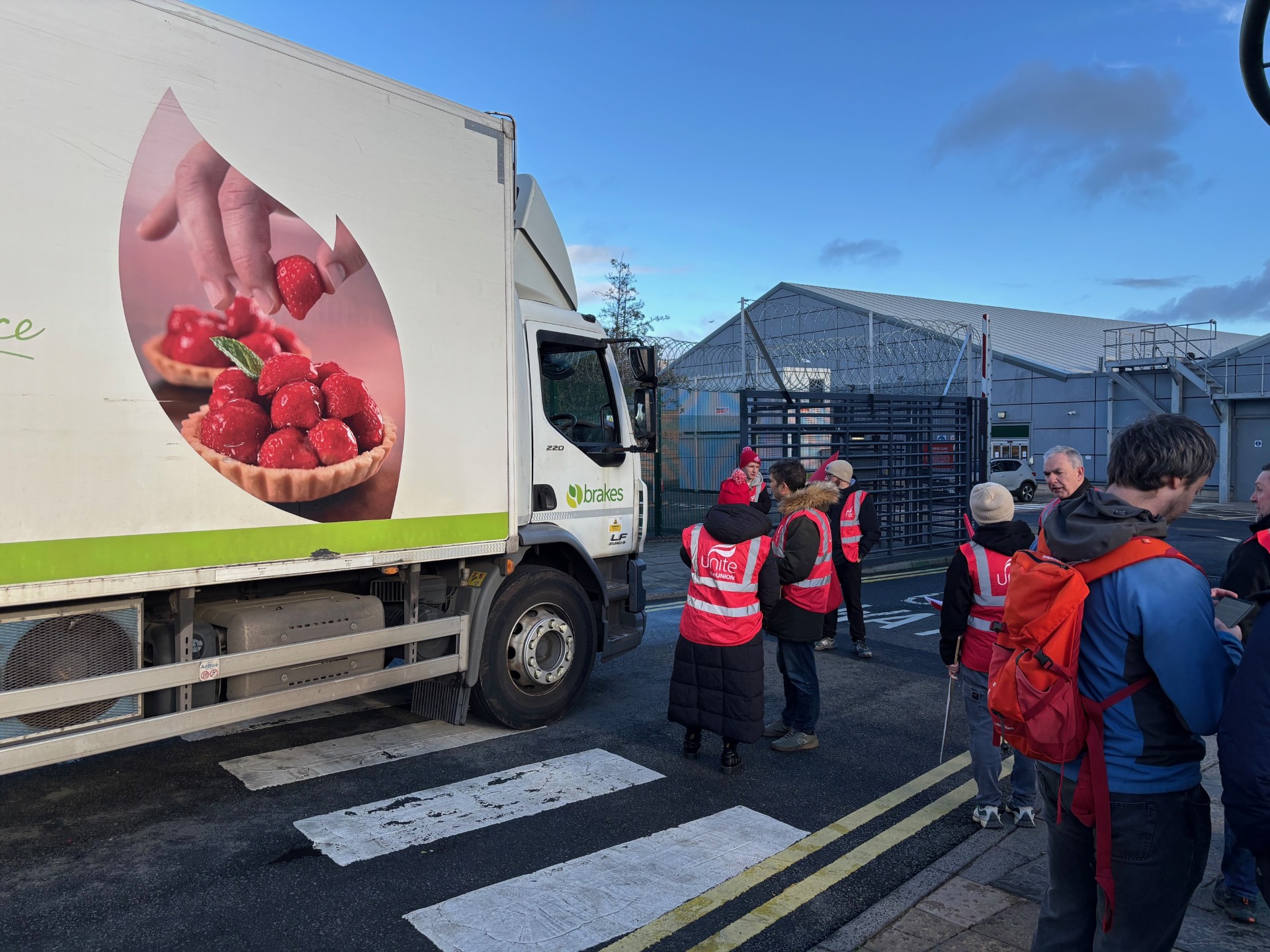 Van and people in red jackets