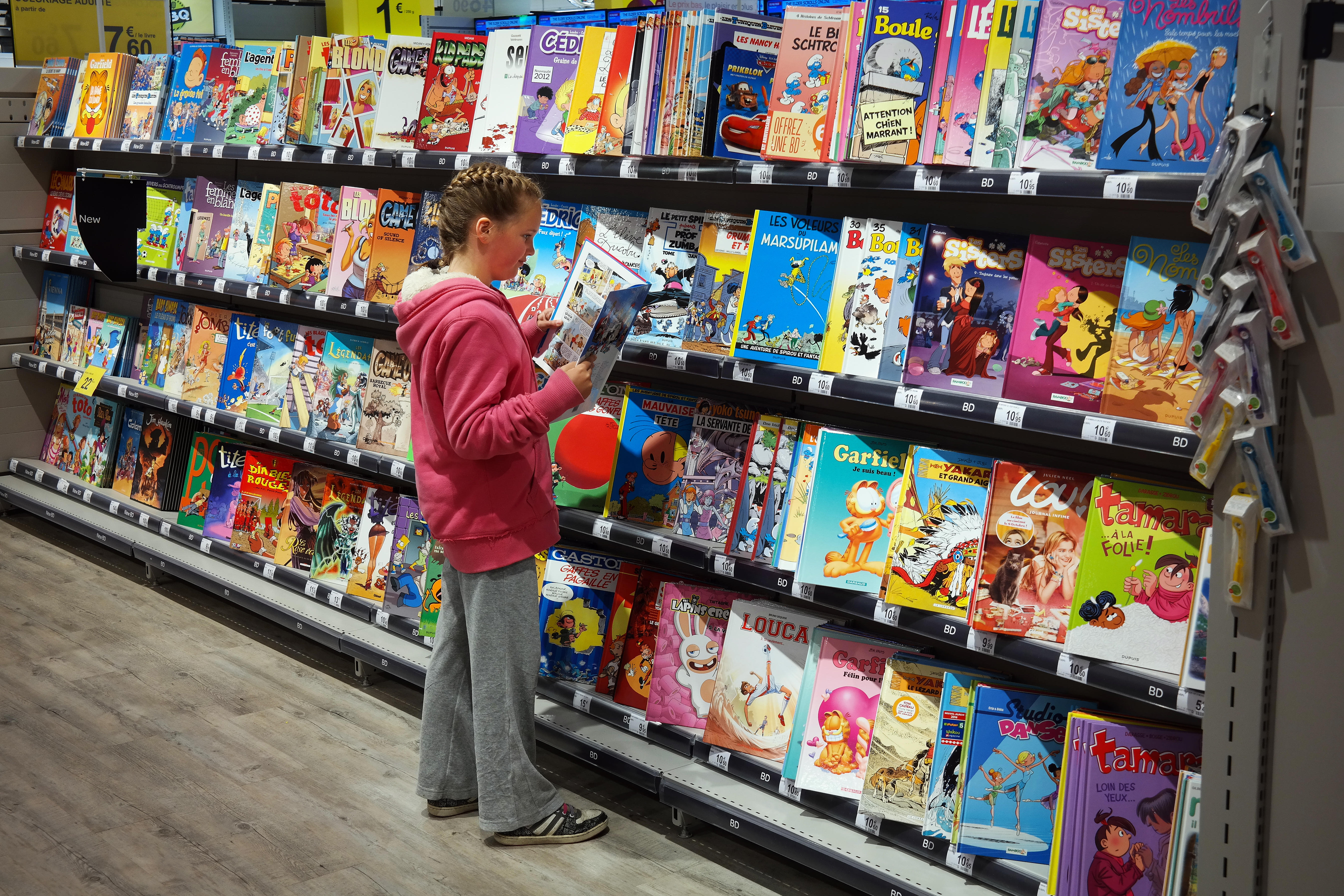 A child looking at books in a shop