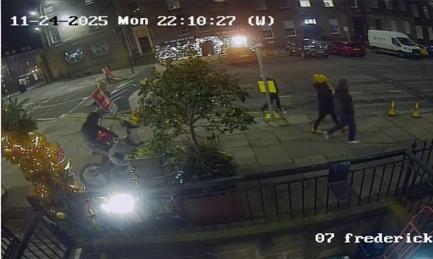 Still image from CCTV of a thief on a bike outside a venue