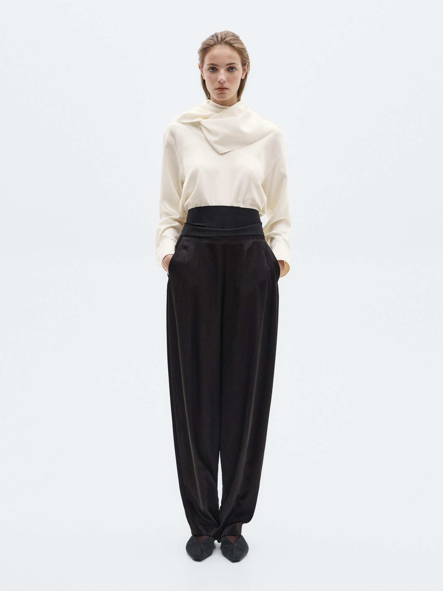 Model wears silk white top