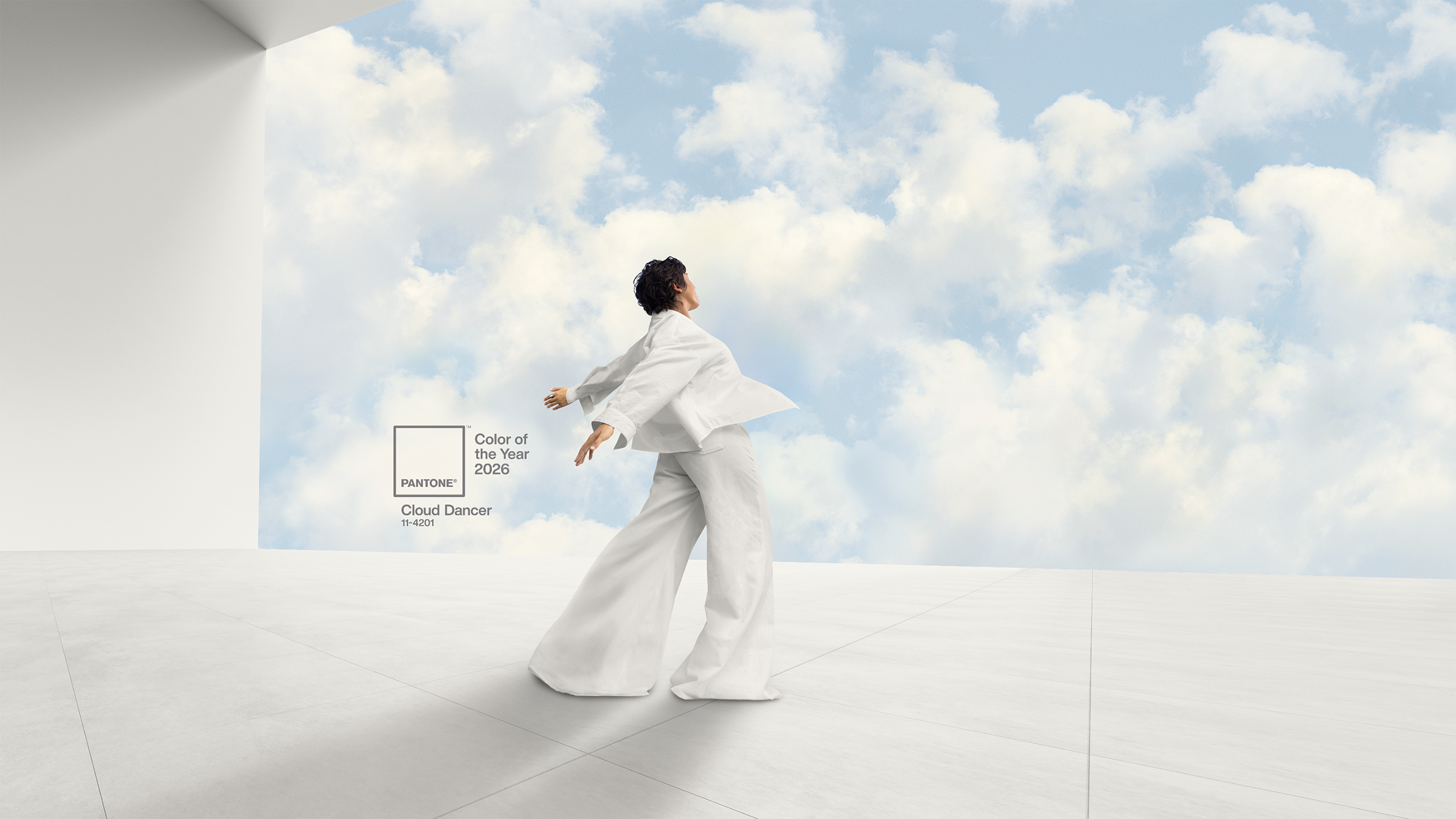 Woman in white dancing in front of sky