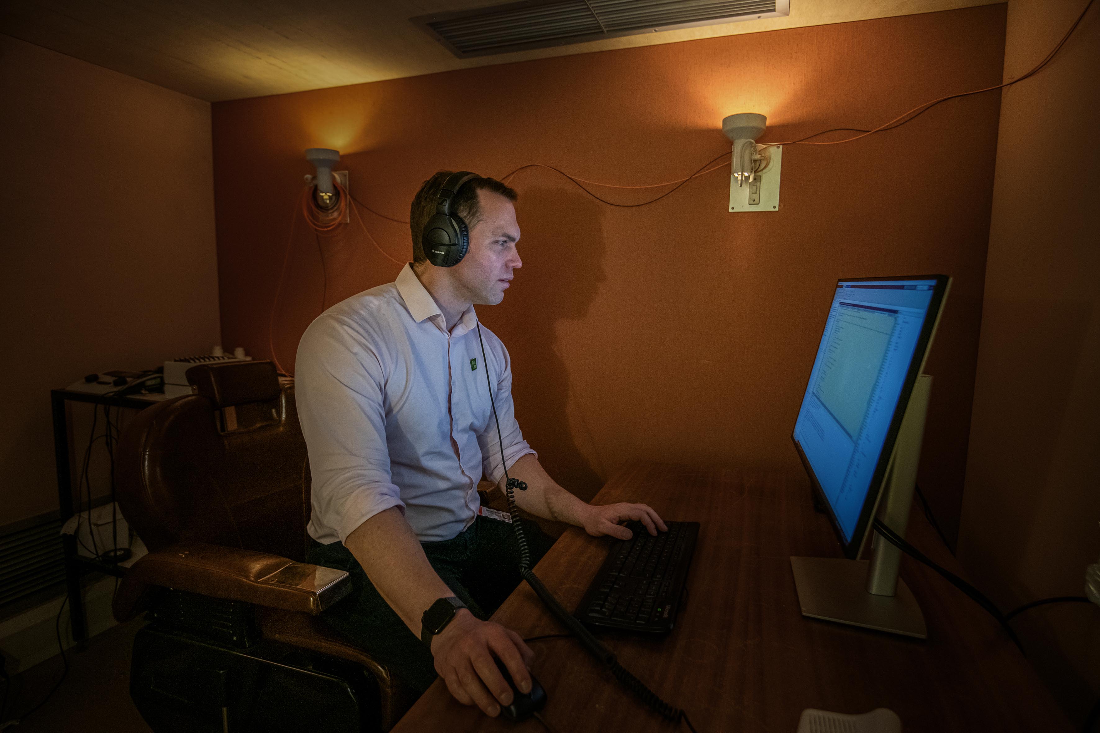 Man wearing headphones using computer