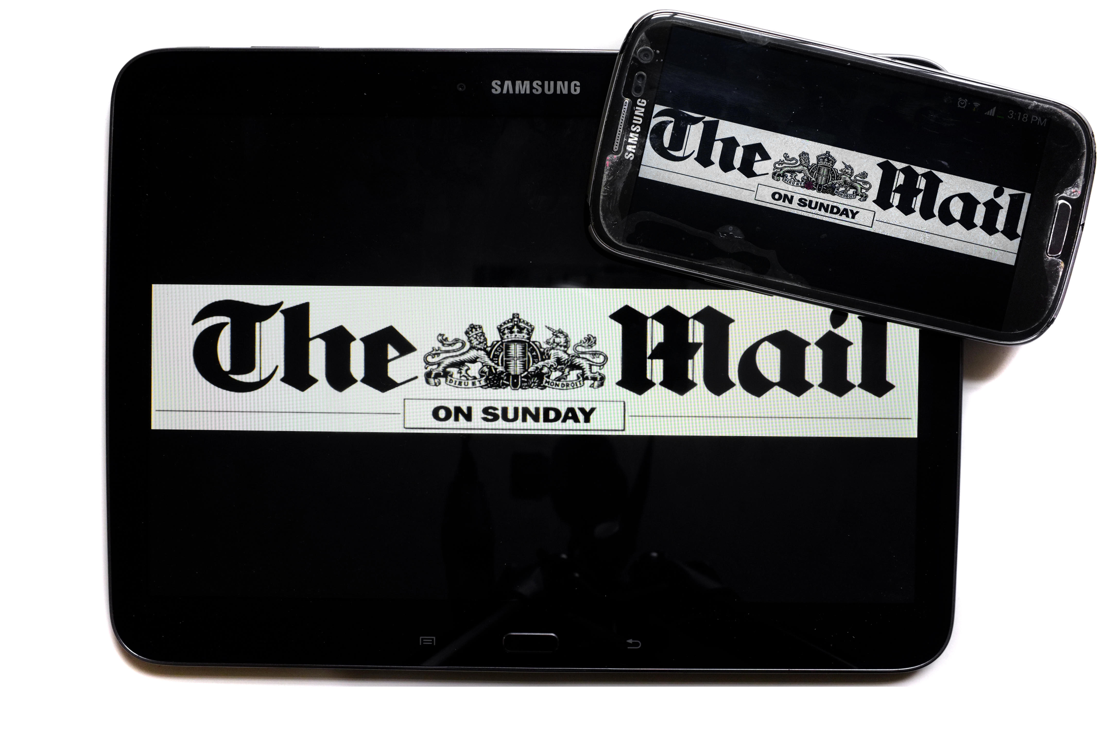 The logo of The Mail on Sunday newspaper displayed on the screens of a tablet and a smartphone