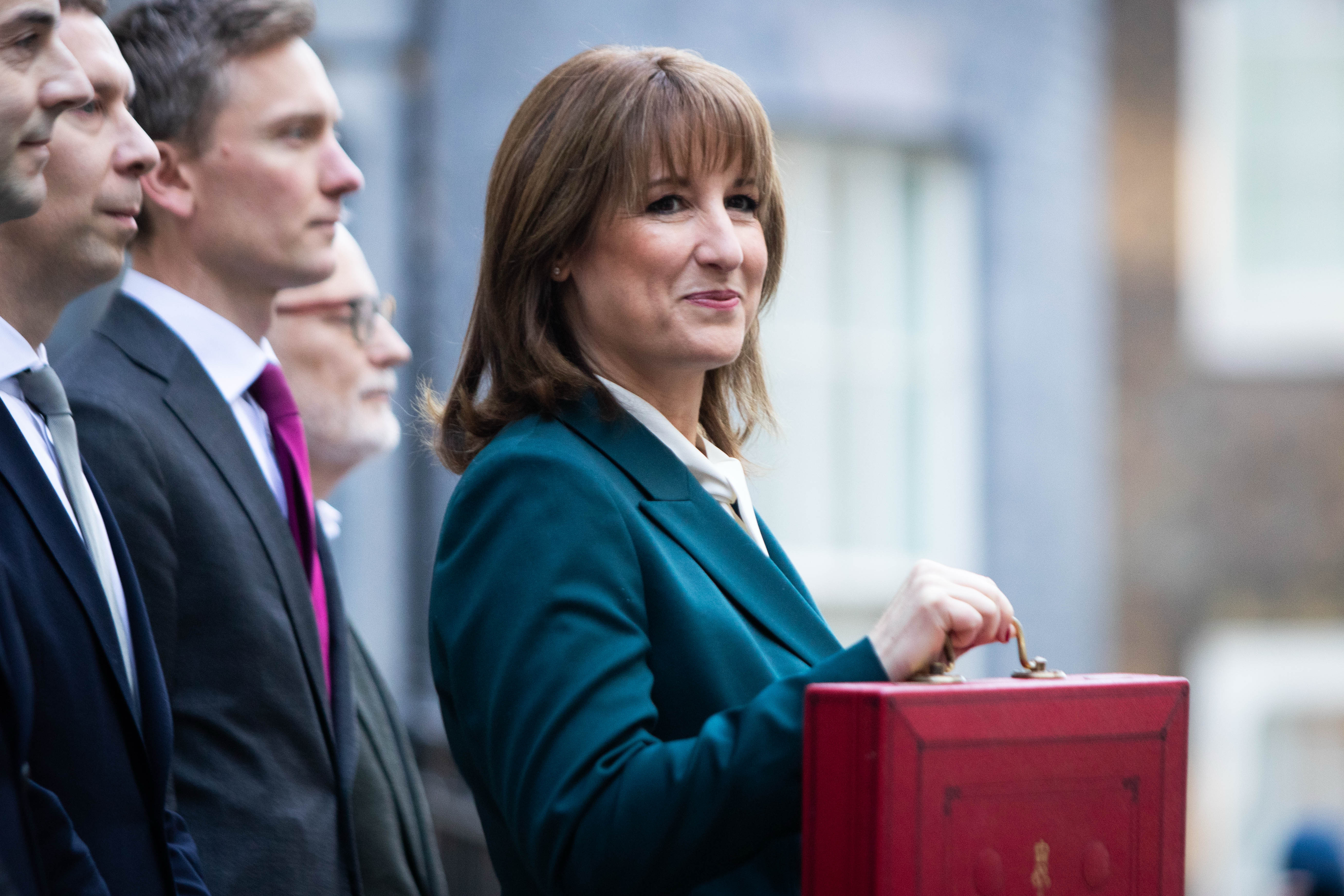 Rachel Reeves posing for photos with her red ministerial Budget box