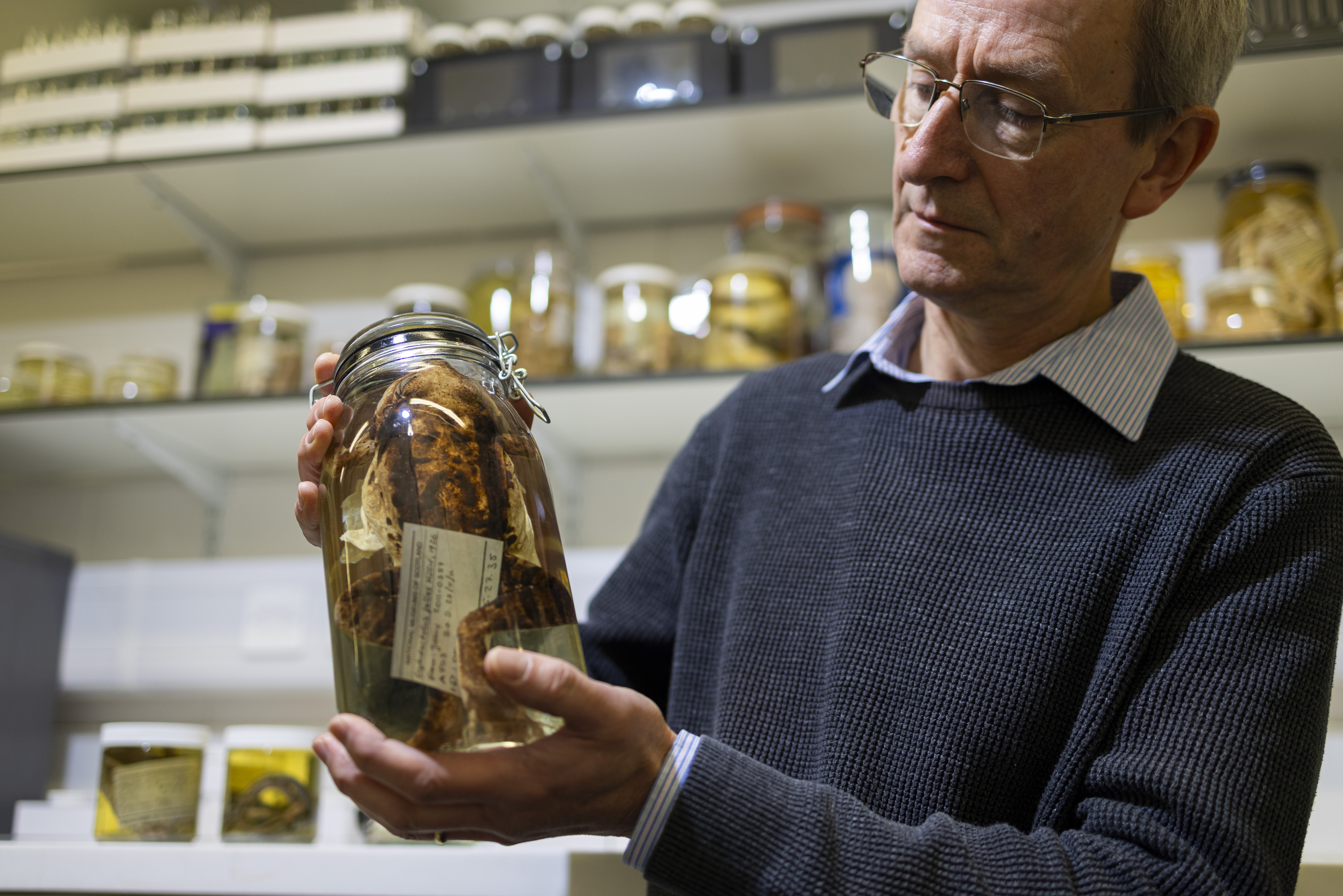 Man holding a specimen jar