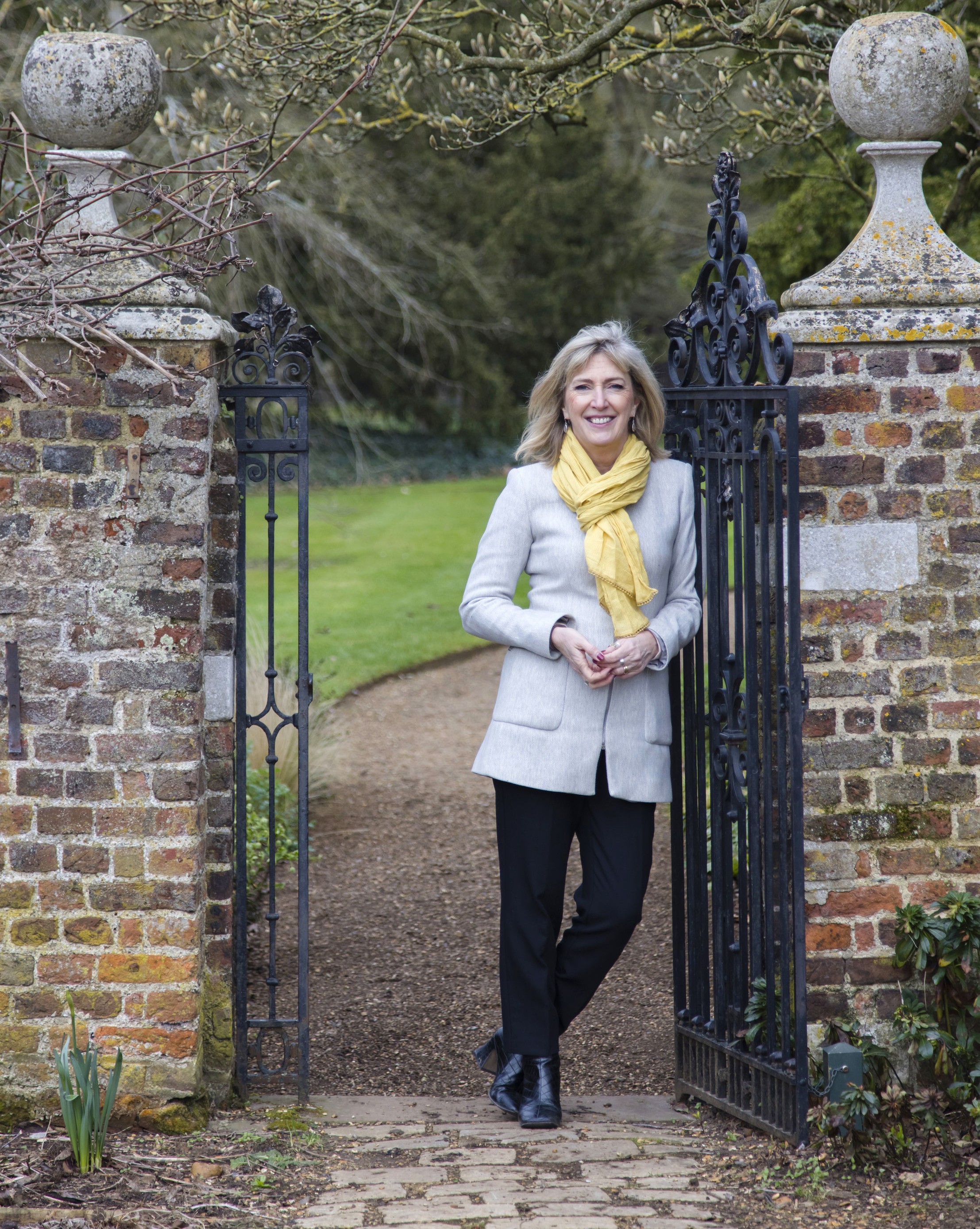 Hilary McGrady leaning on a gatepost
