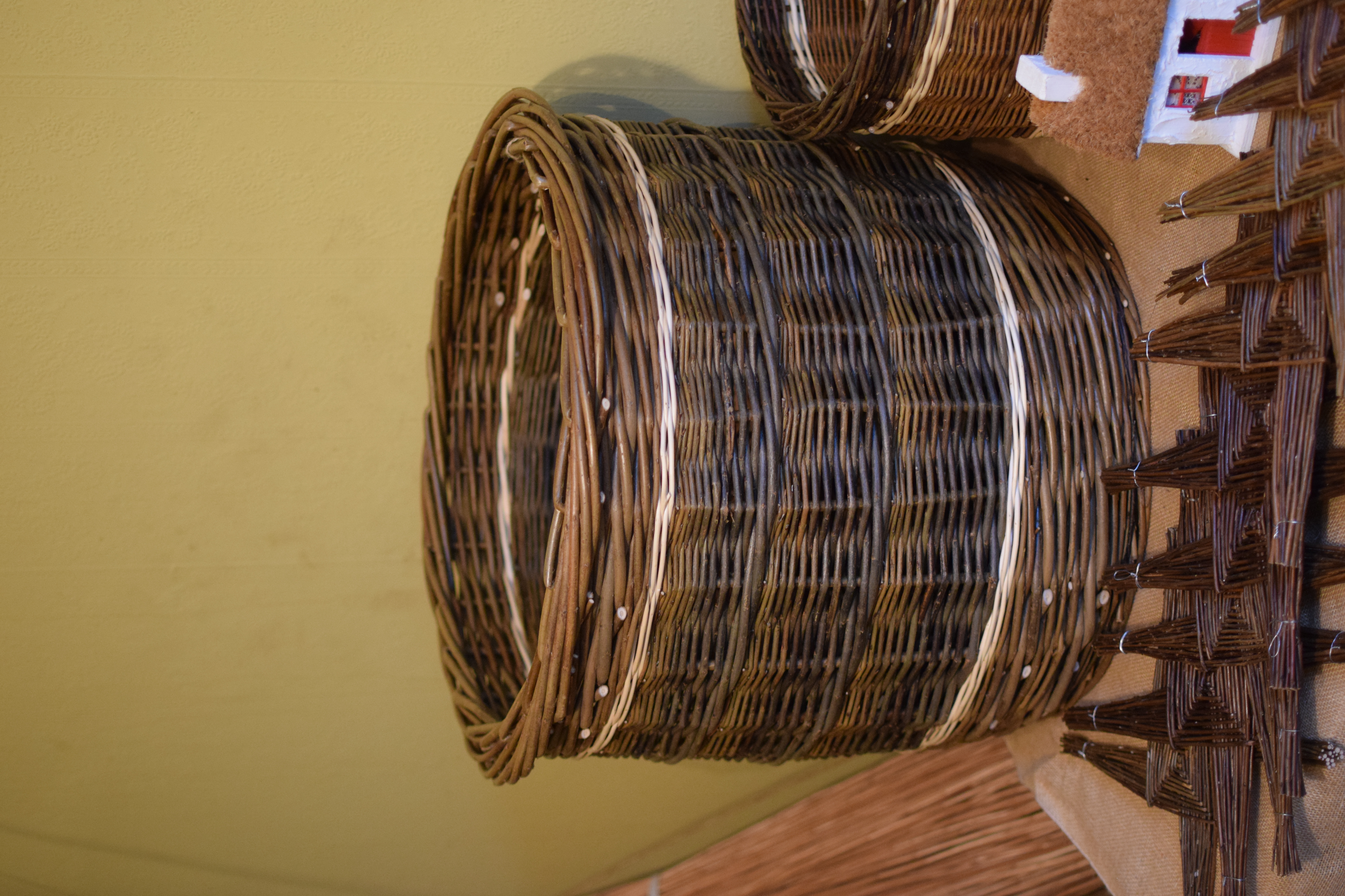A weaved basket sitting among other weaved items