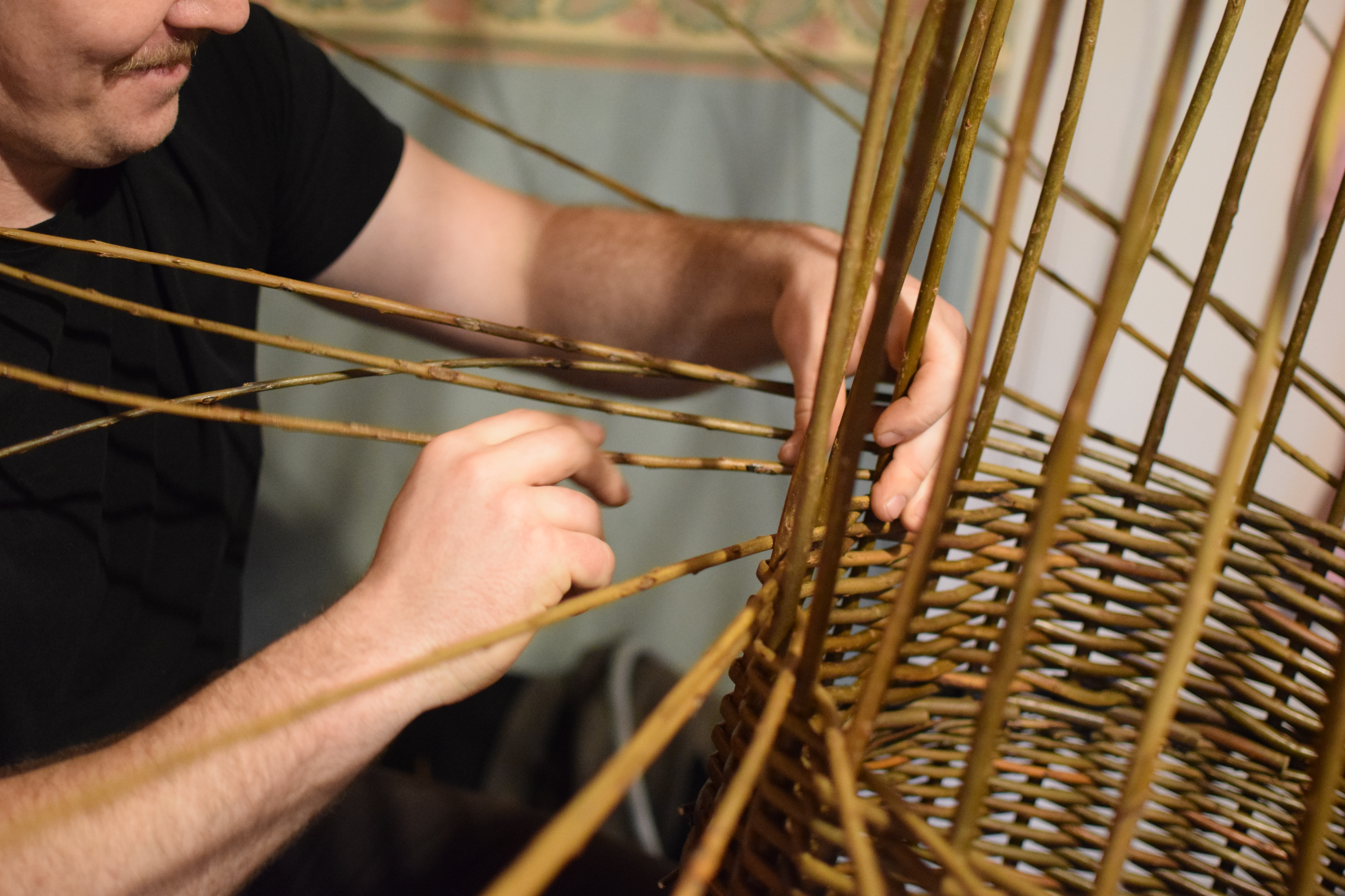Tom Delaney at work weaving a basket