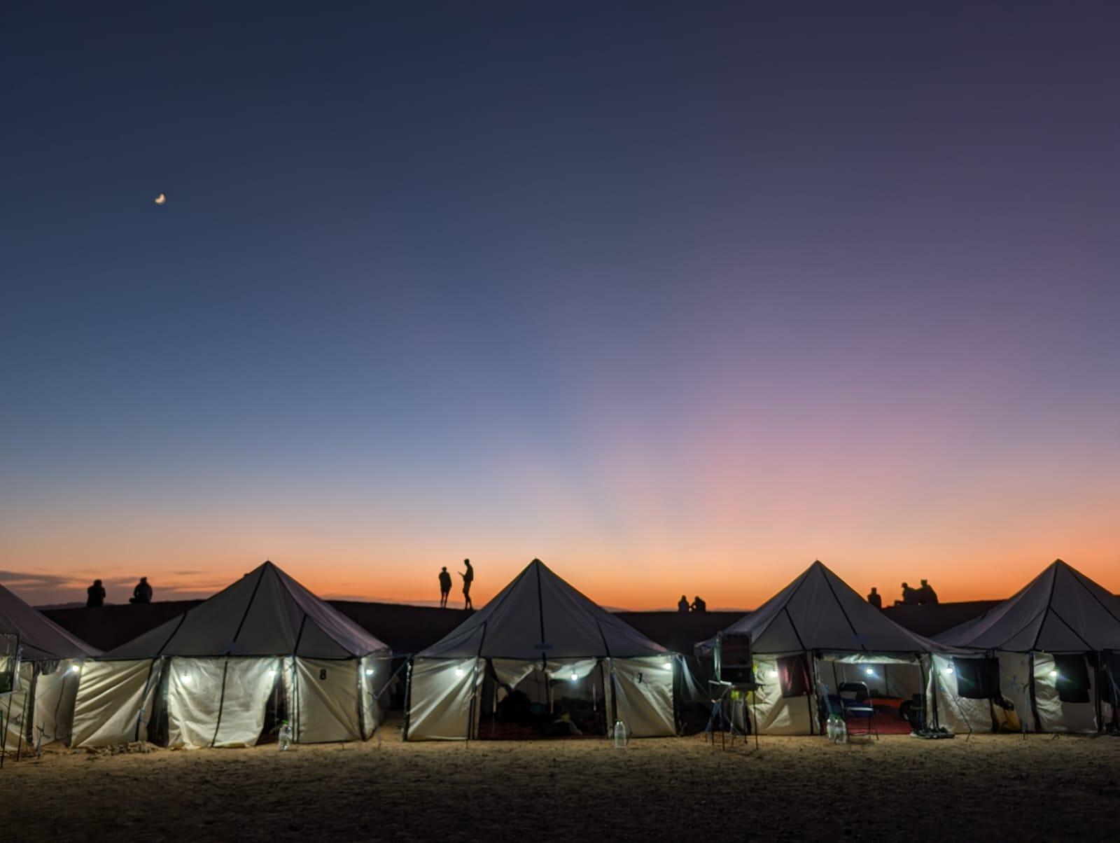 Tents in the desert at sunset