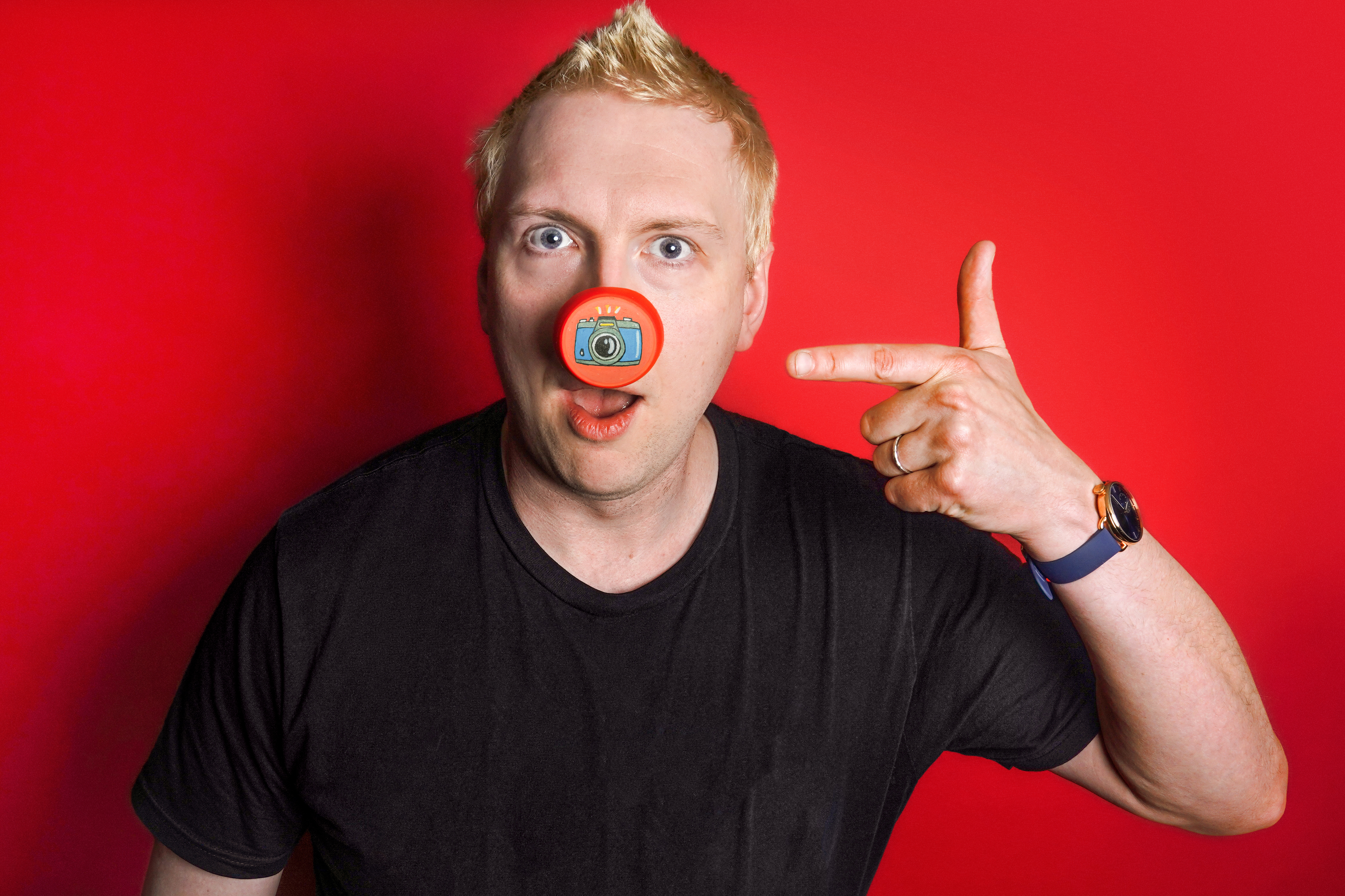 Comedian Joe Lycett supports Red Nose Day 2026 by wearing one of the new Design-Yer Noses