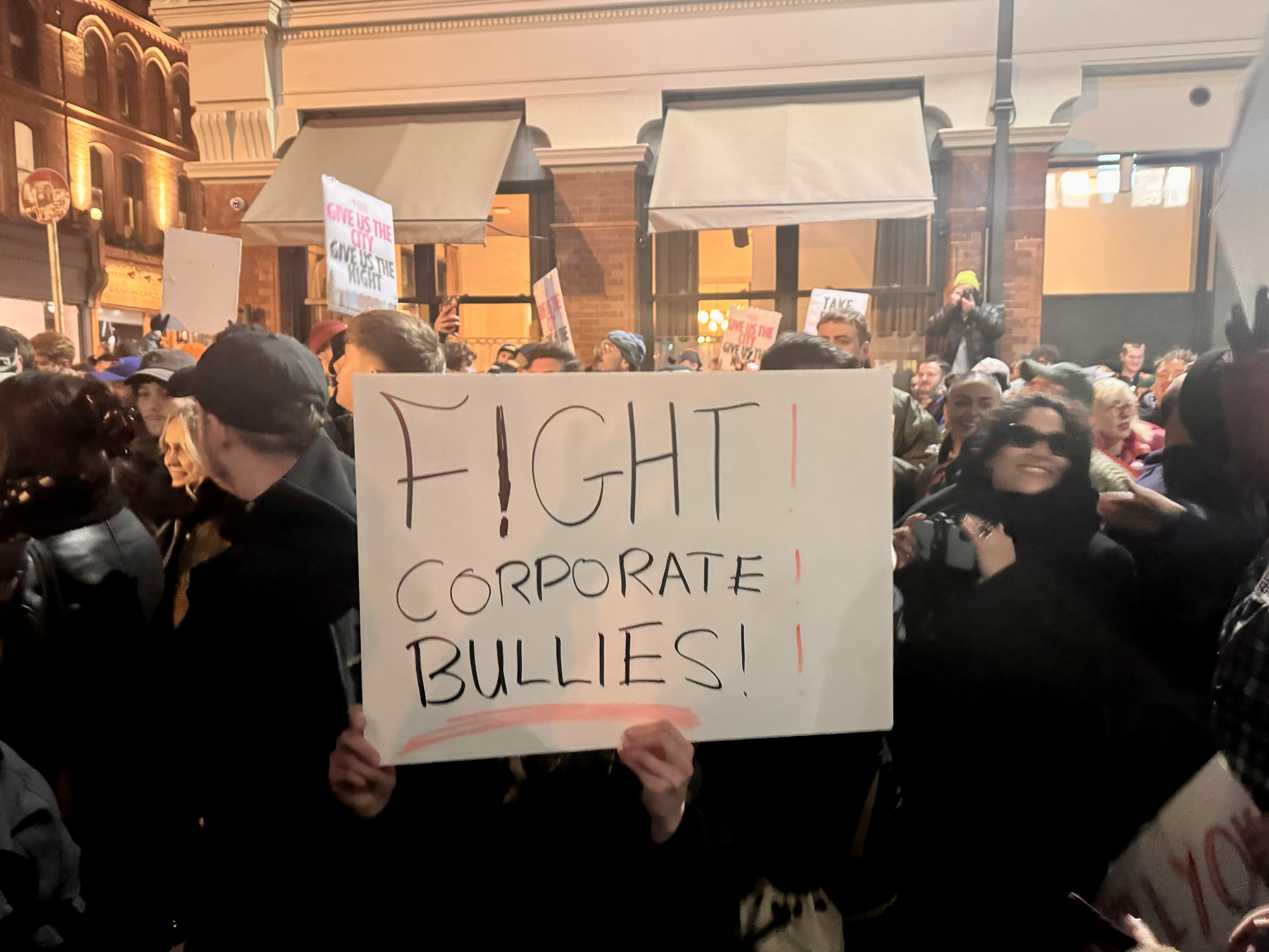 A sign reading Fight corporate bullies