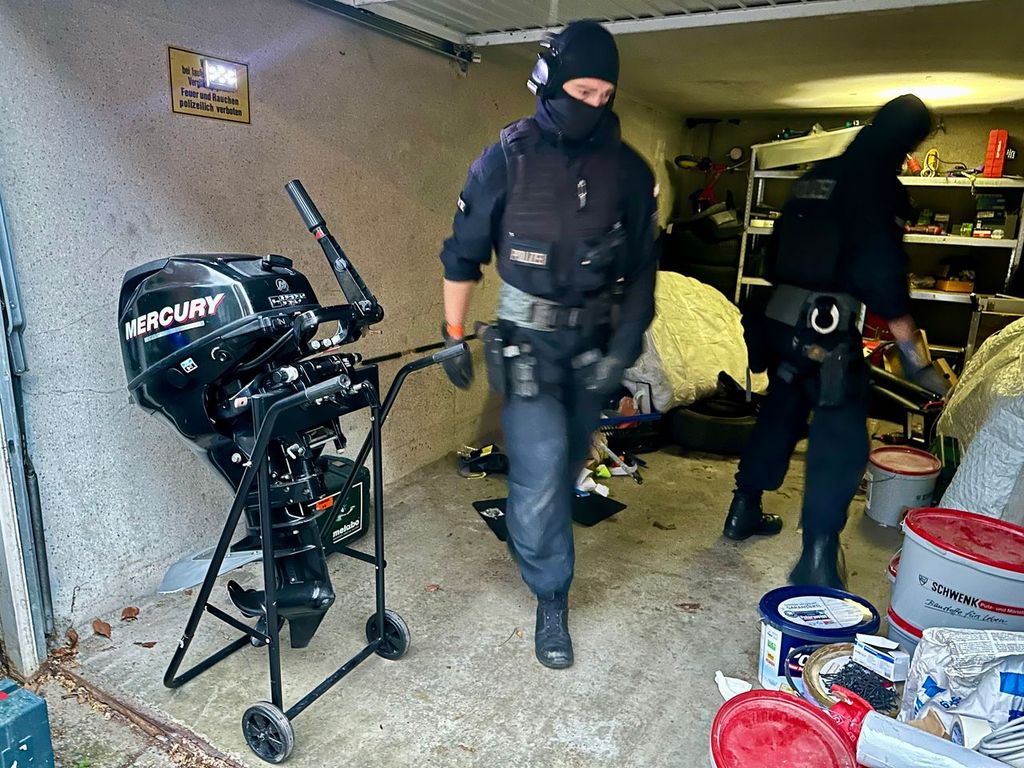 An officer moves a boat engine