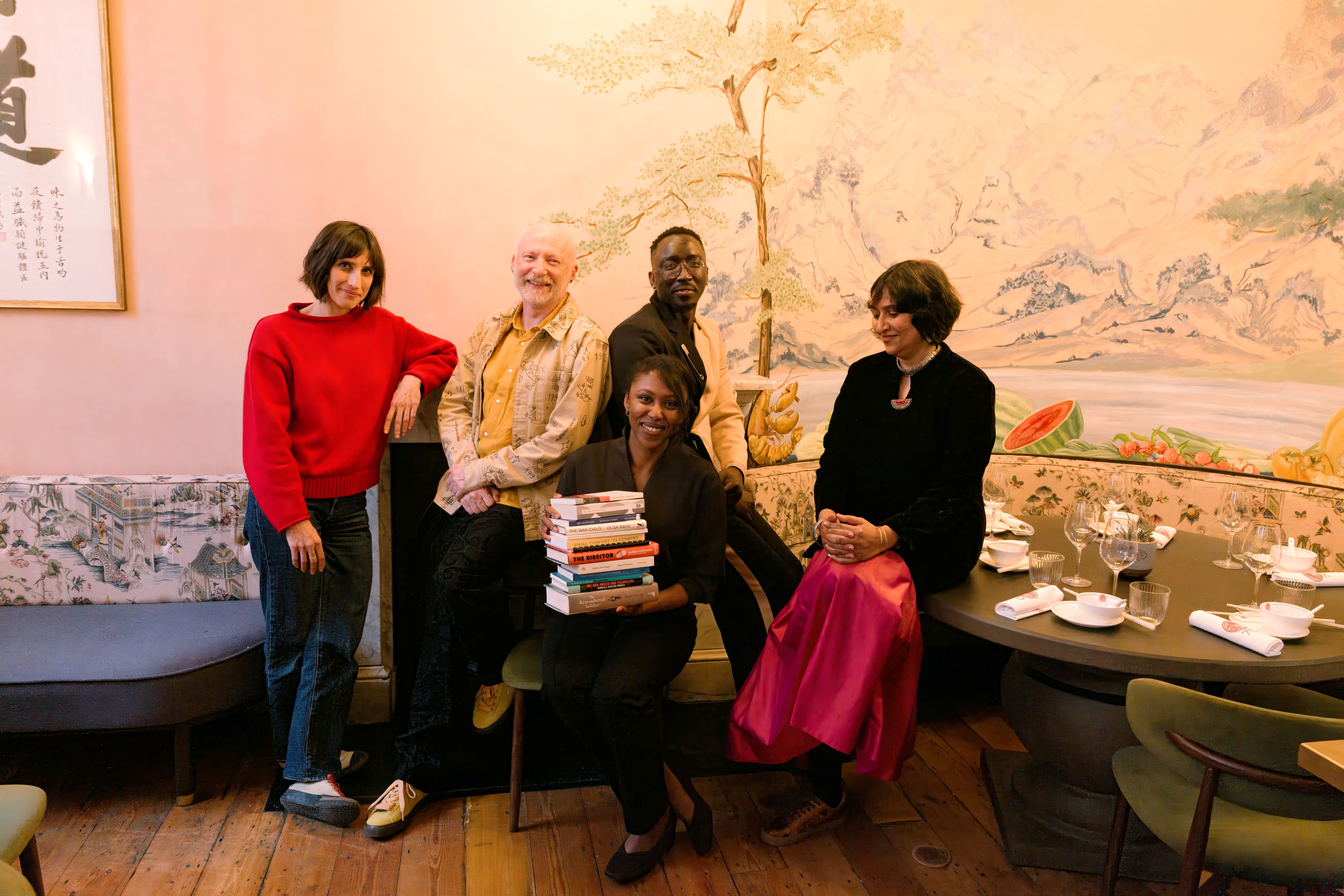 The judges group with books on the longlist
