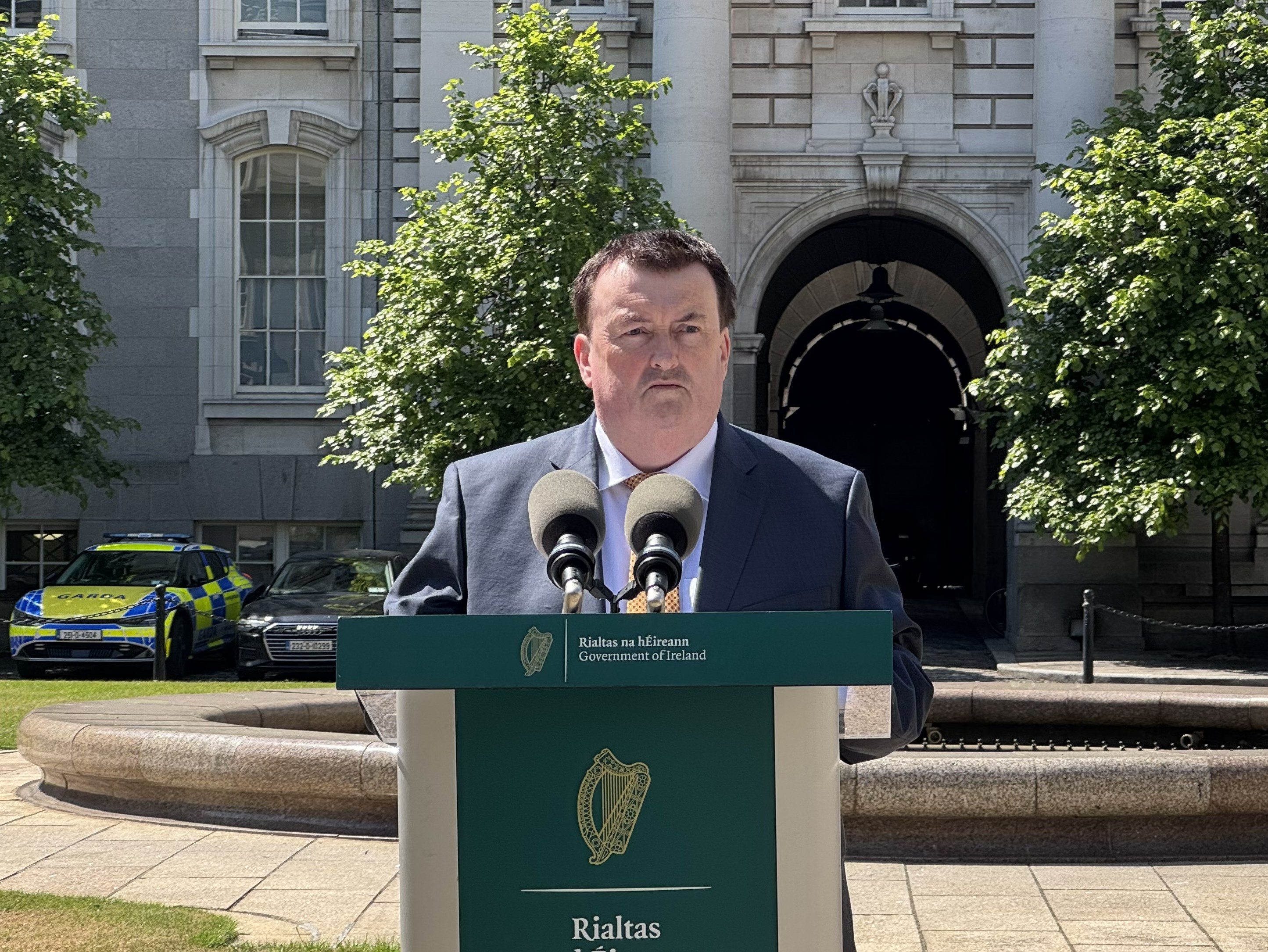Colm Brophy standing behind a podium