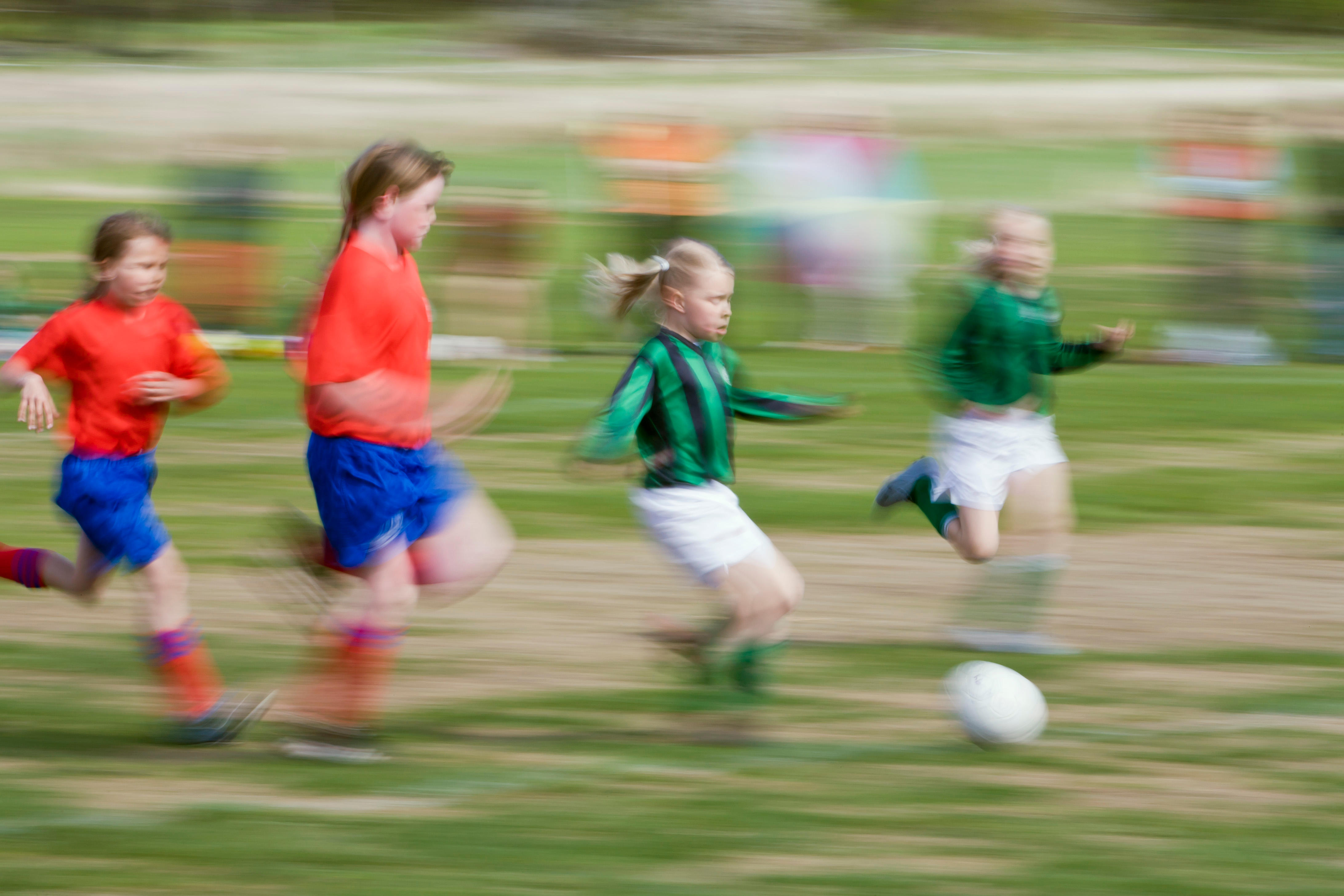 Girls running on the football pitch