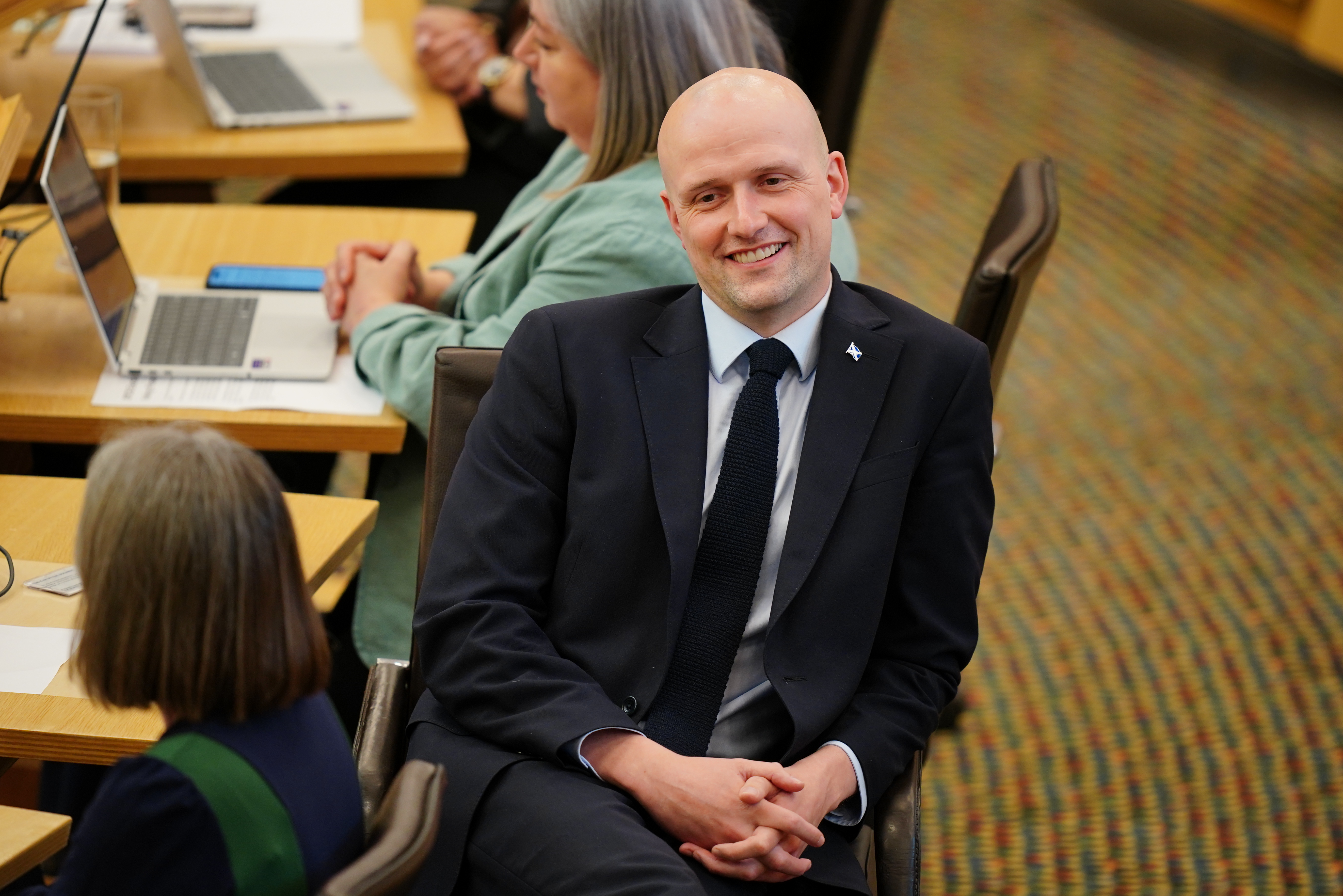 Stephen Flynn smiling while seated in Holyrood