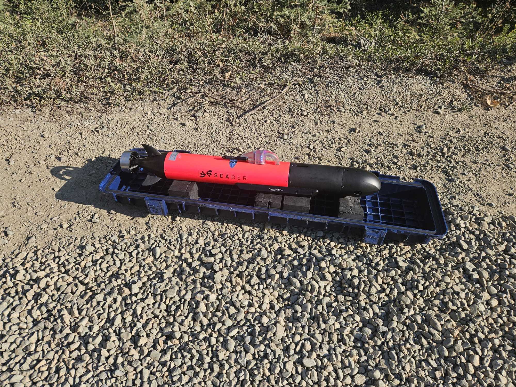 A small autonomous underwater vehicle sitting on a beach