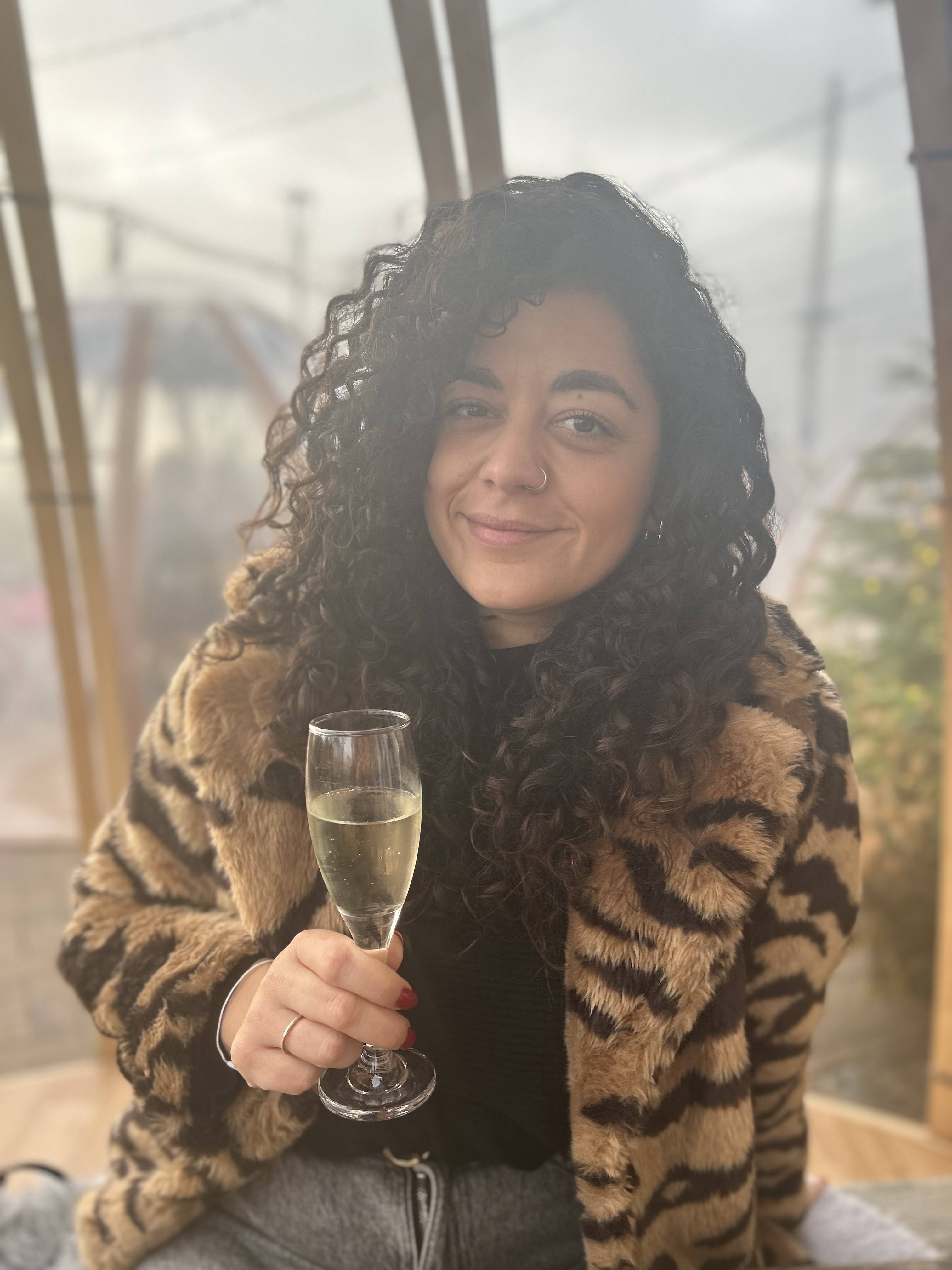Heart transplant patient Hannah Sharma holding a glass of wine and smiling