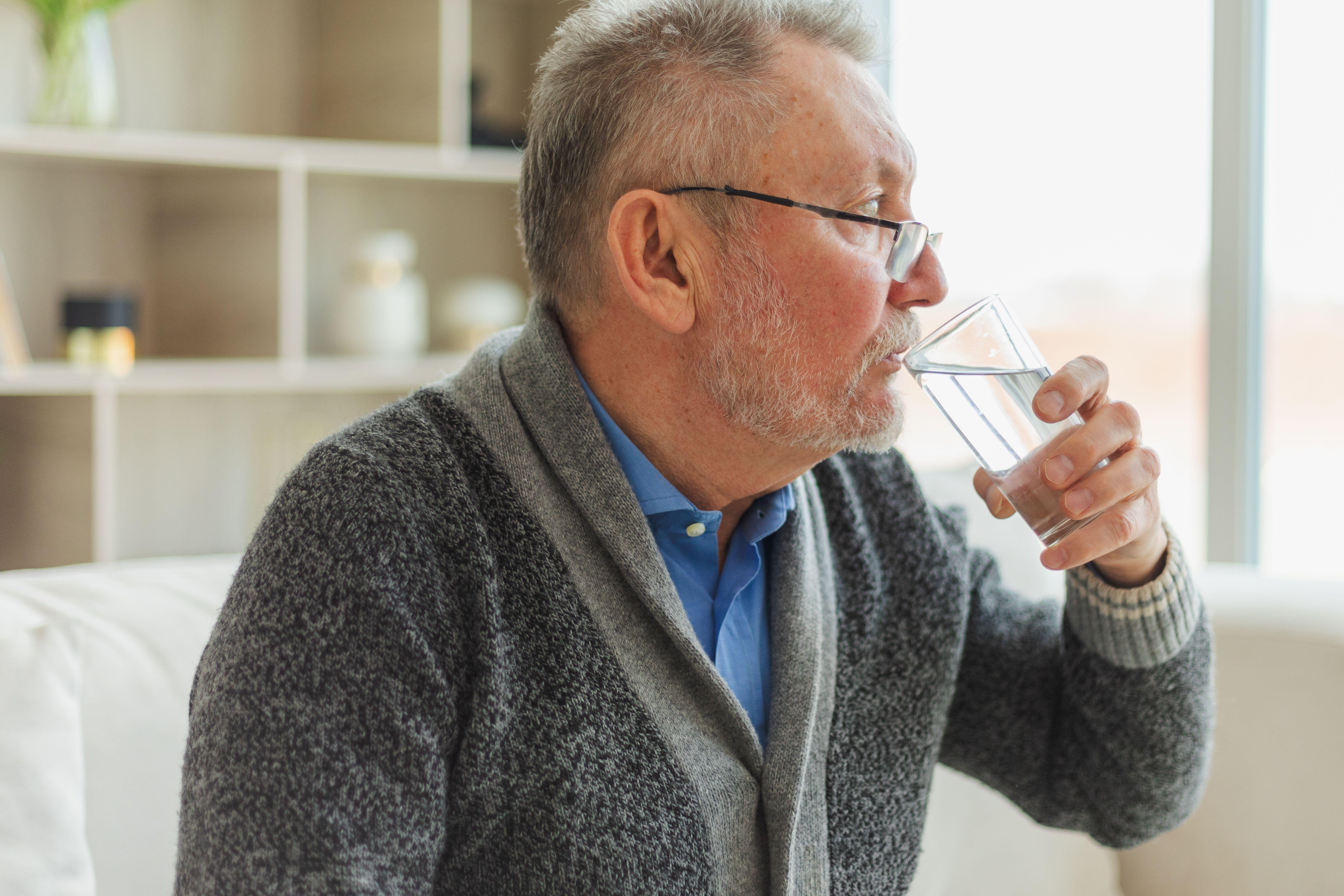 Senior man drinking glass of water