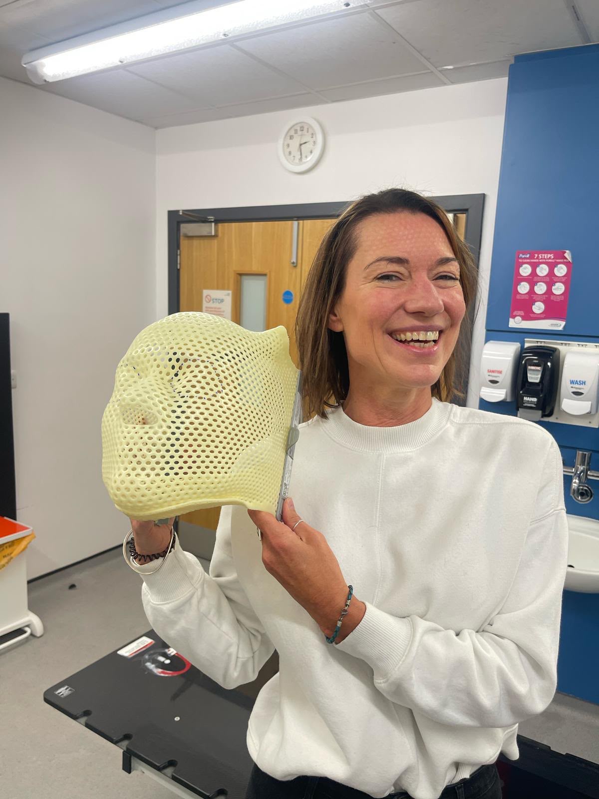 Jo Fuller holding her radiotherapy mask