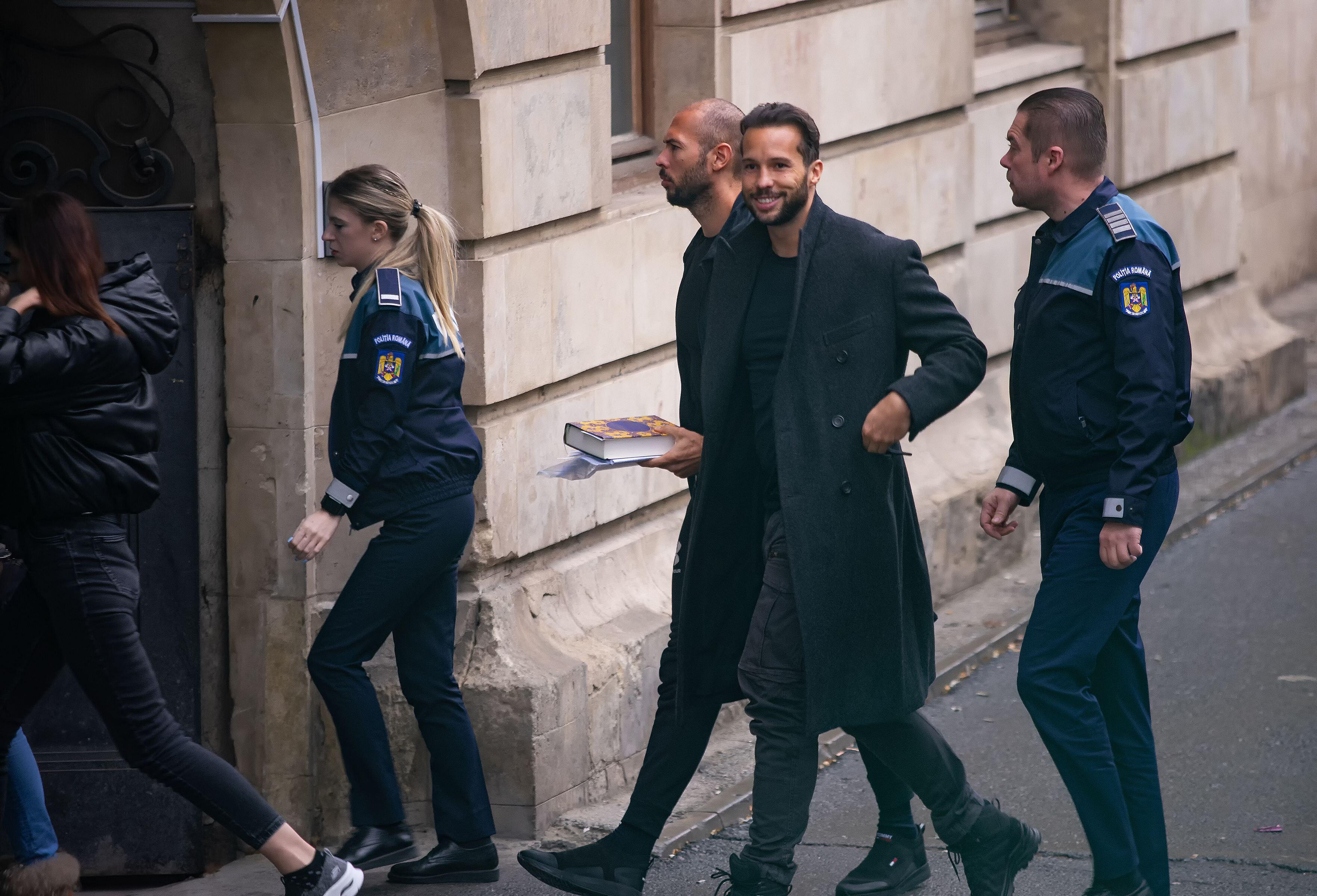Andrew Tate and his brother Tristan arrive in handcuffs at the Bucharest Court of Appeal