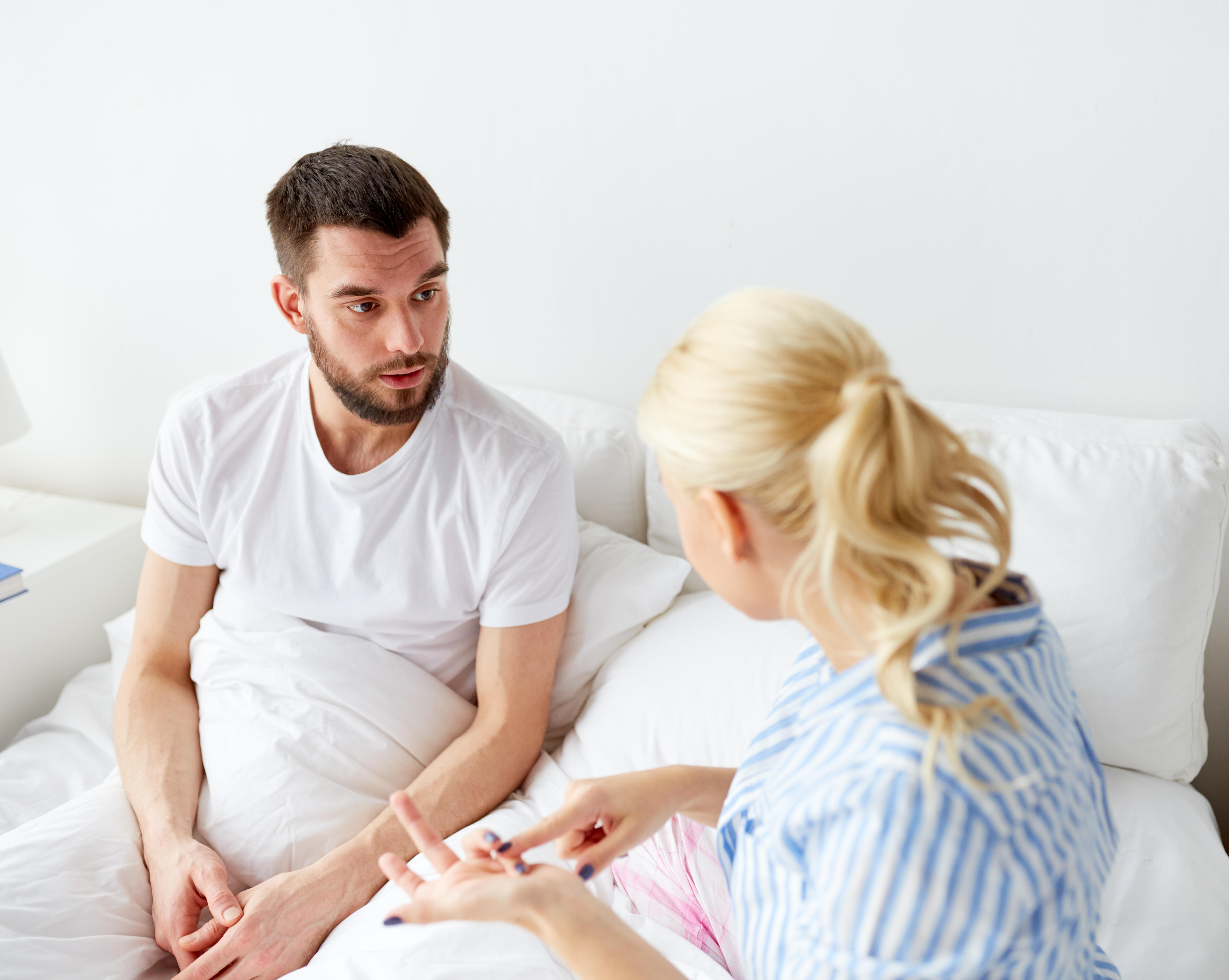 Couple having a serious conversation in bed