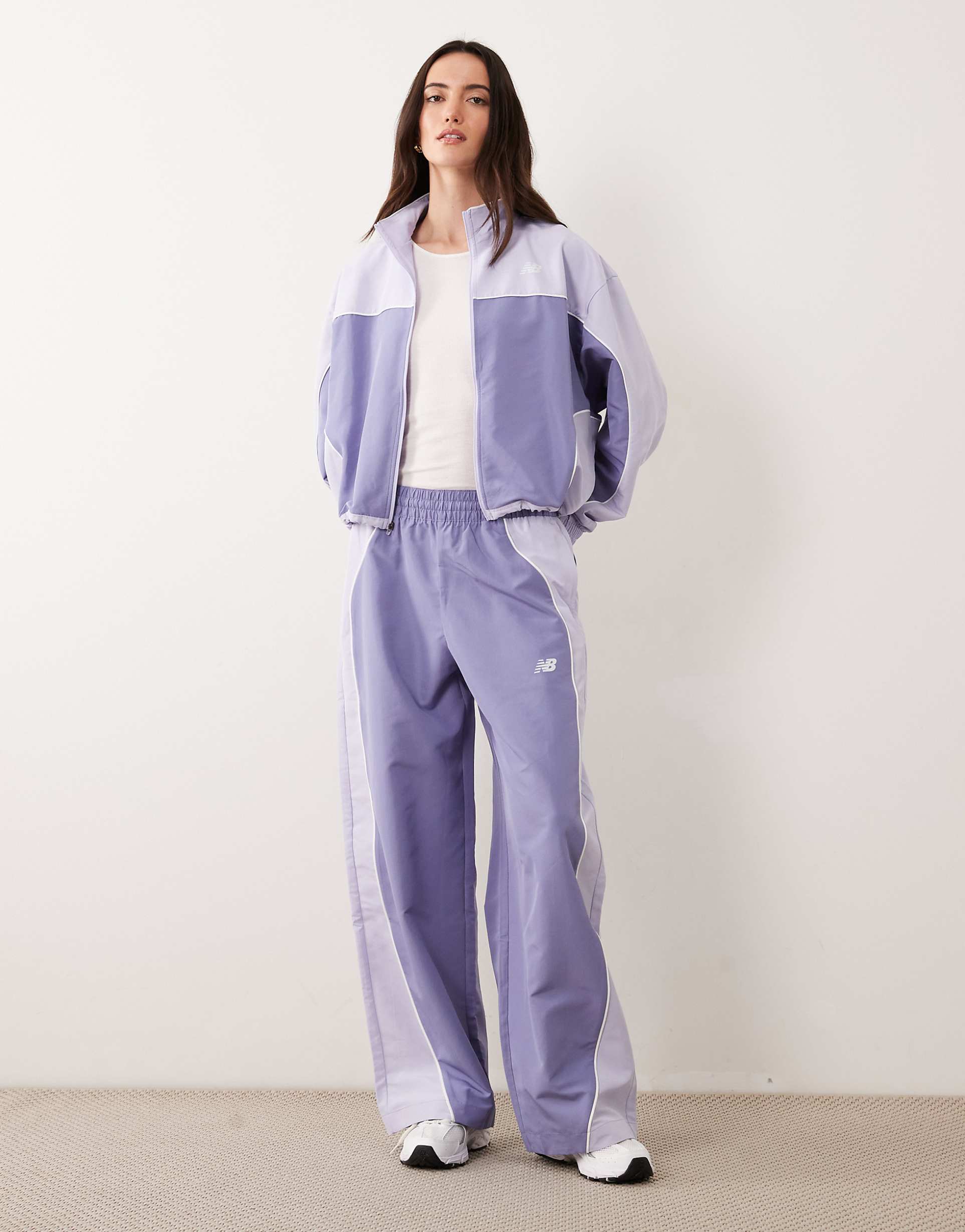 New Balance Trackside Woven Pant in Dark Smoked Violet, £65; New Balance Trackside Woven Jacket in Dark Smoked Violet, £85, ASOS