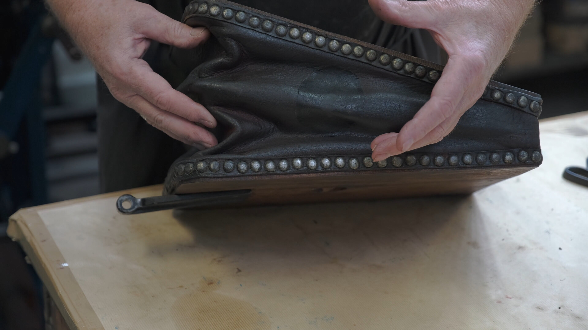 Hands holding a printing press bellow