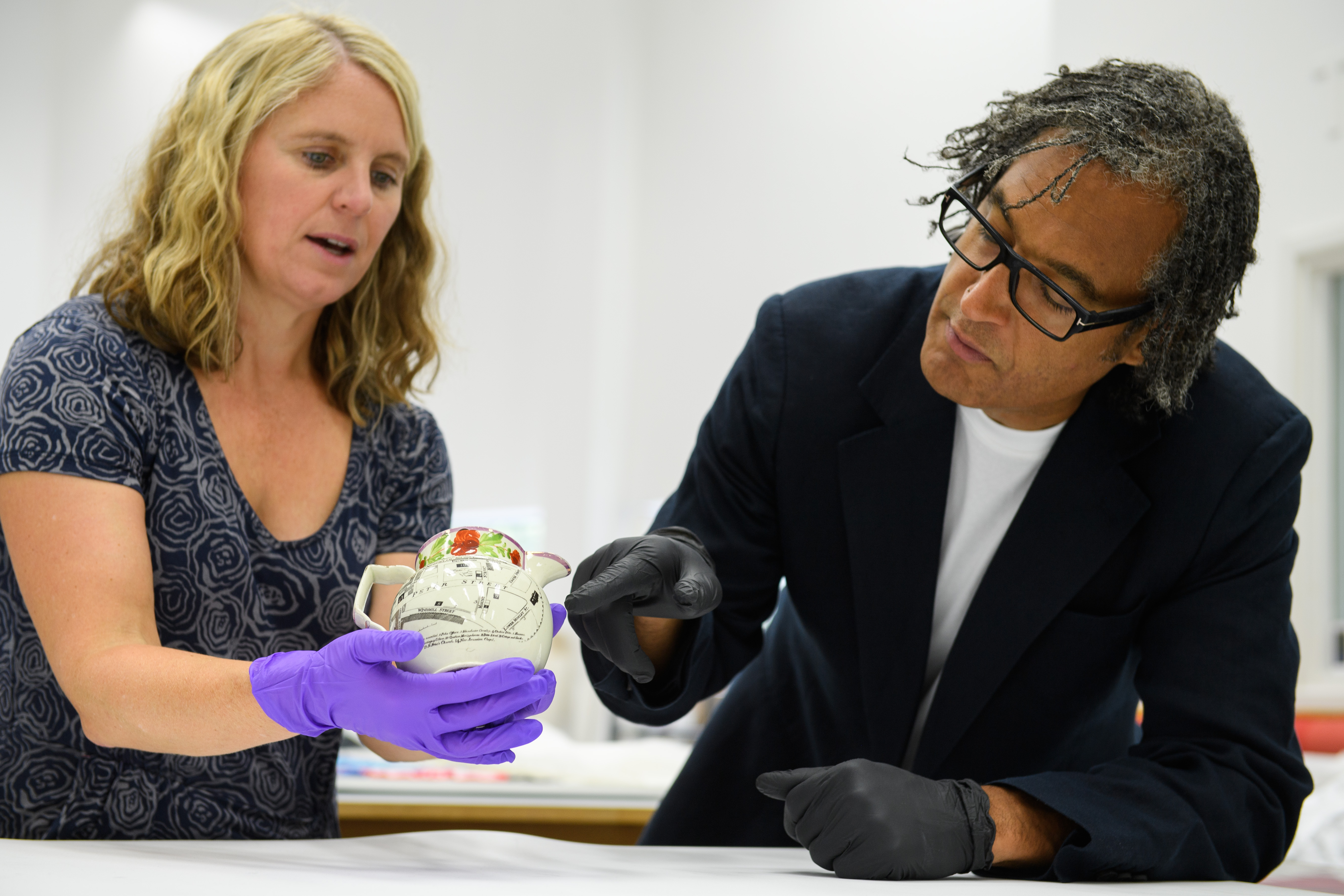 David Olusoga examines a teapot