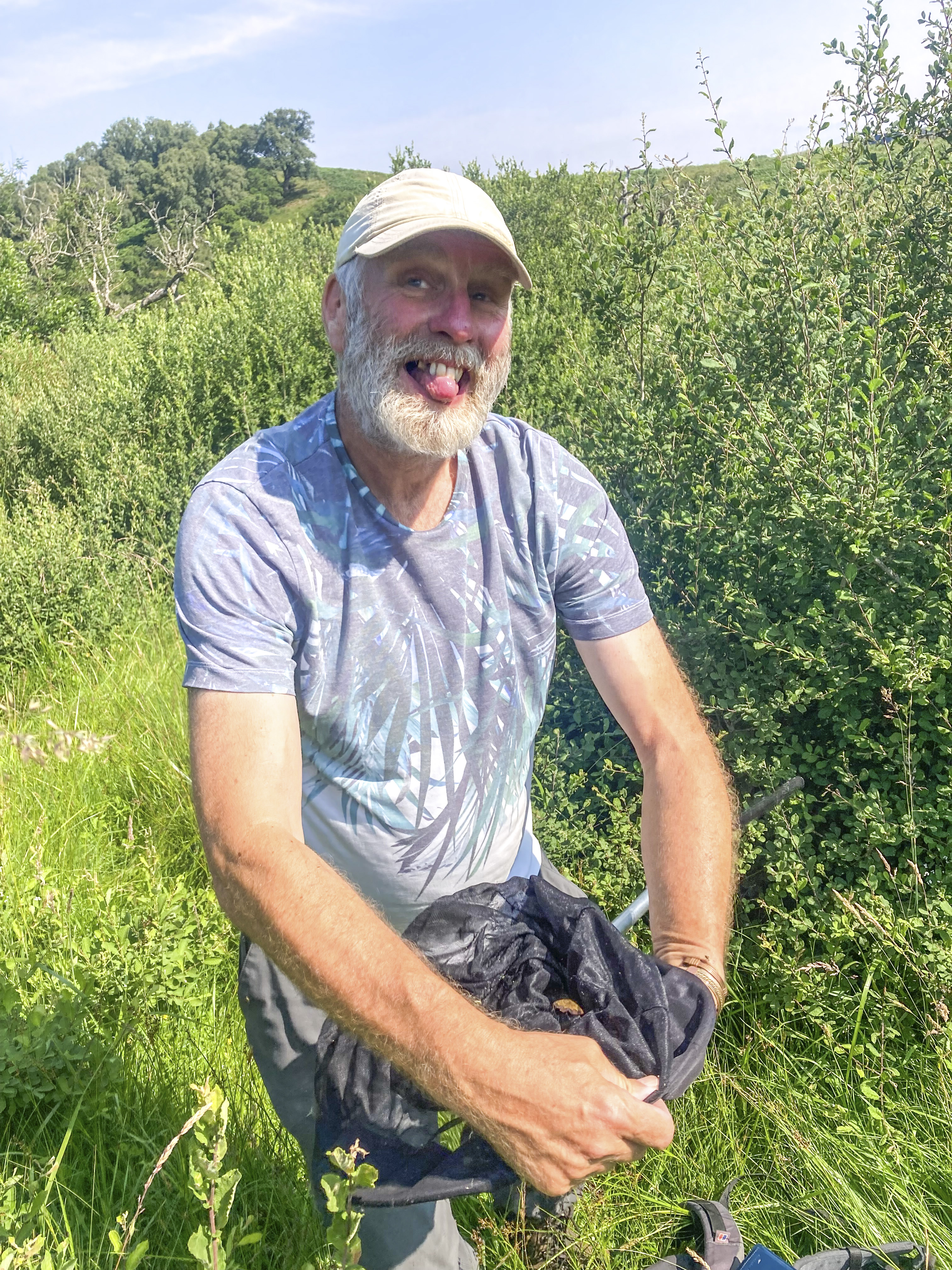 Dave Wainwright holds a net with a moth in it at Wallington