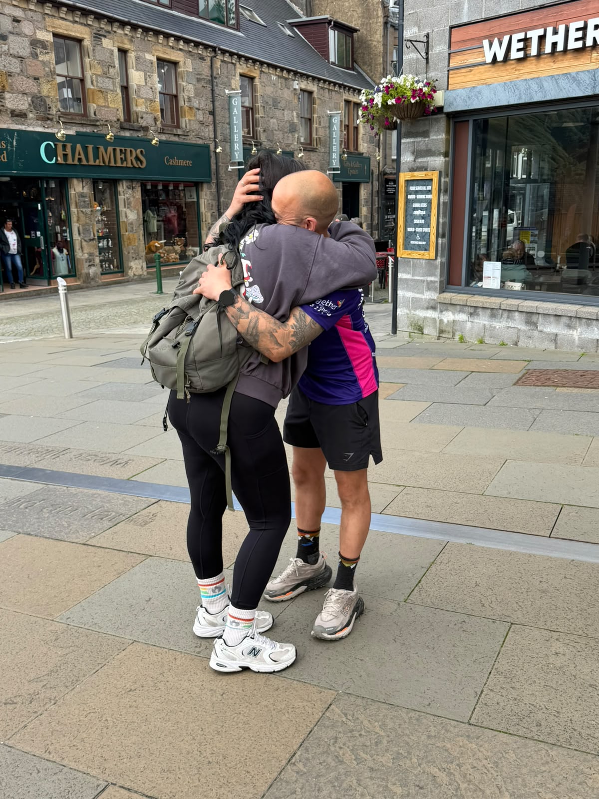 Benjamin Ward and Natasha Goldthorpe hugging on a street