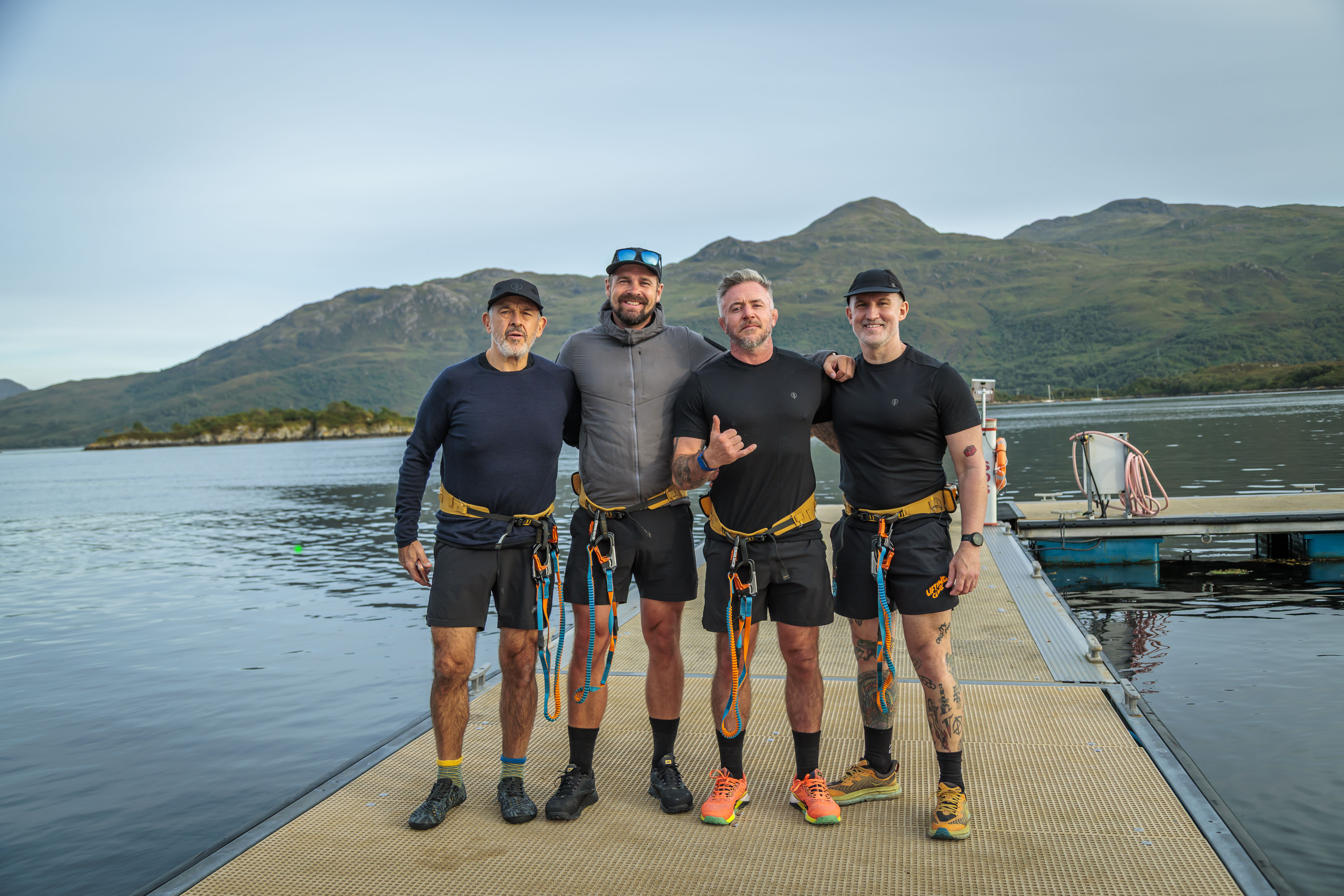 Four rowers stading on a jetty