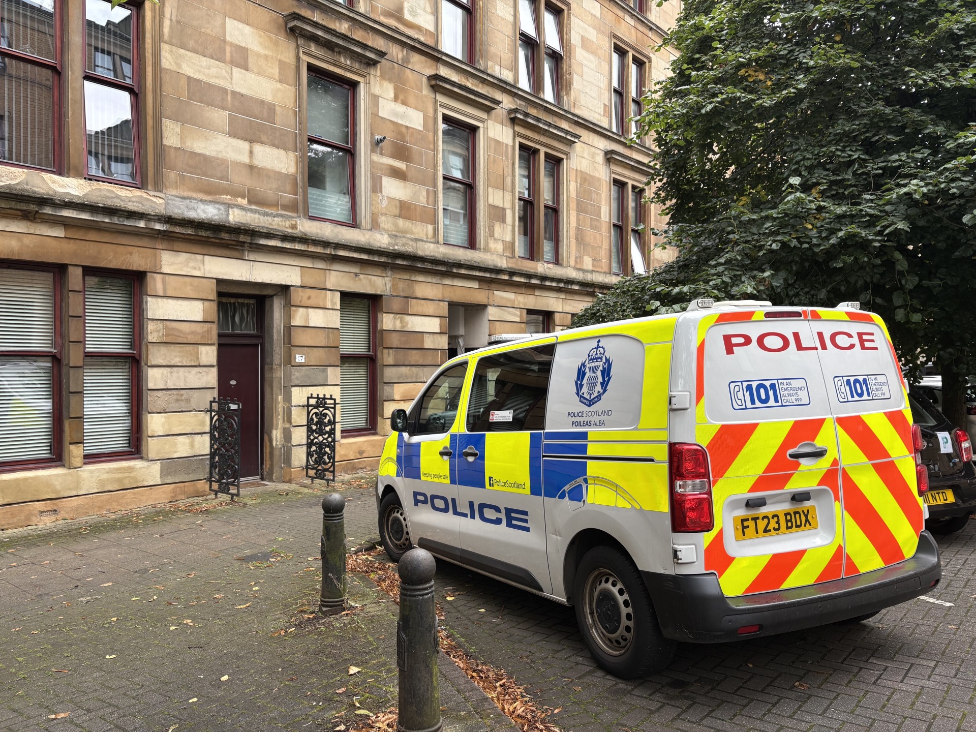 Police van outside a block of flats