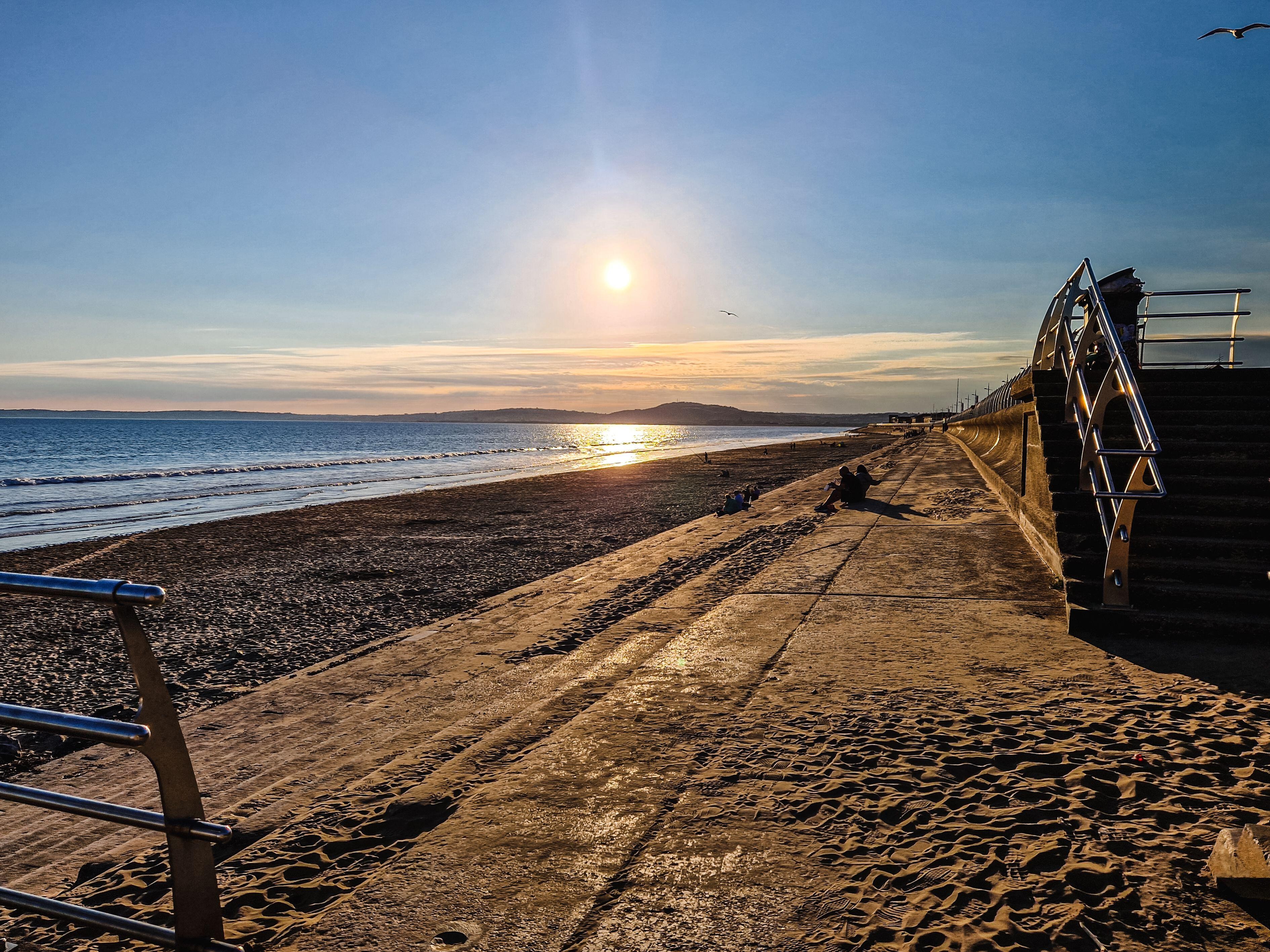 View of a beach, with the sun setting
