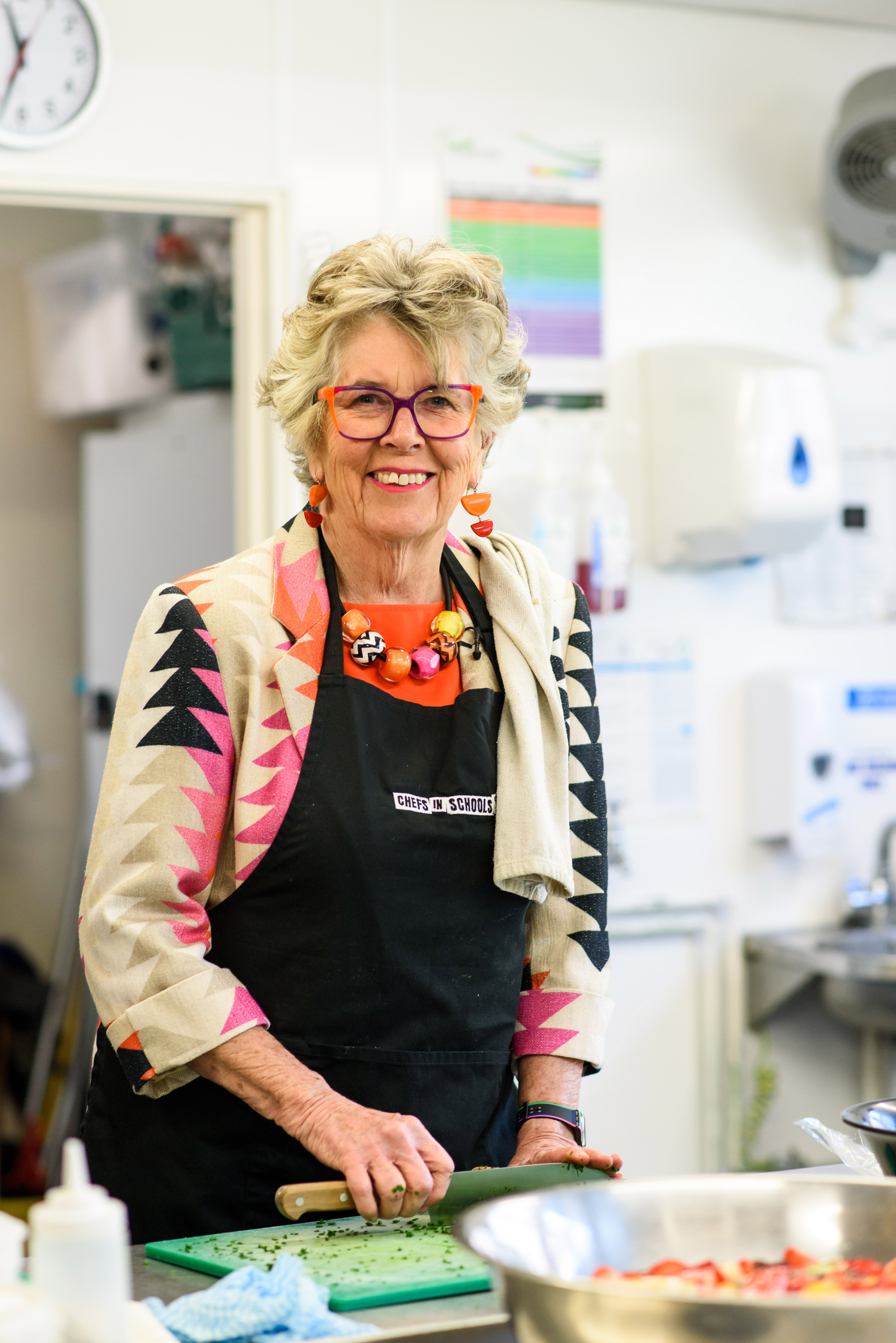 Dame Prue in a school ktichen